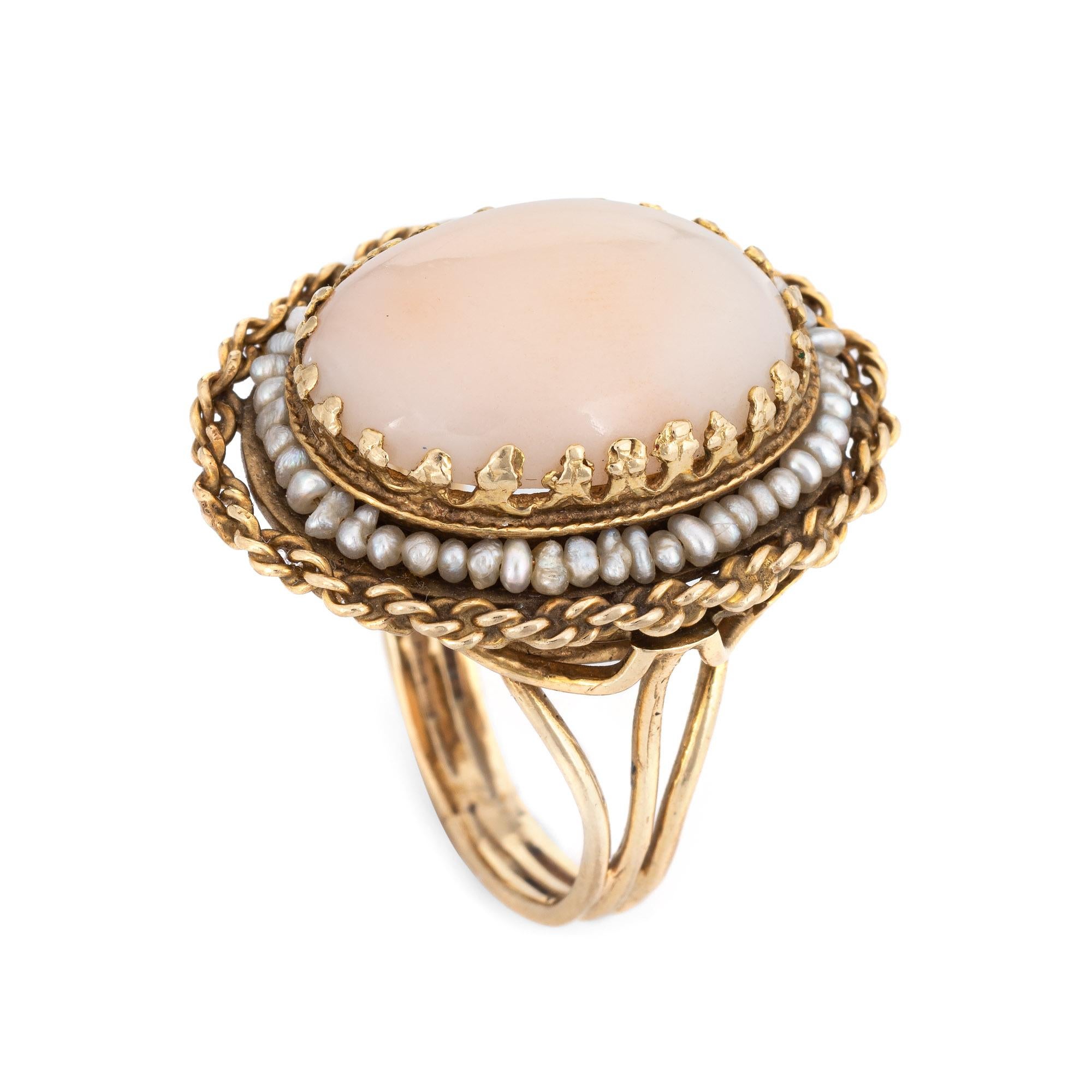 Stylish vintage coral & seed pearl cocktail ring (circa 1960s) crafted in 14 karat yellow gold. 

Coral cabochon measures 18mm x 13mm (estimated at 10 carats). The natural seed pearls measure (average) 1mm. The coral is in very good condition and