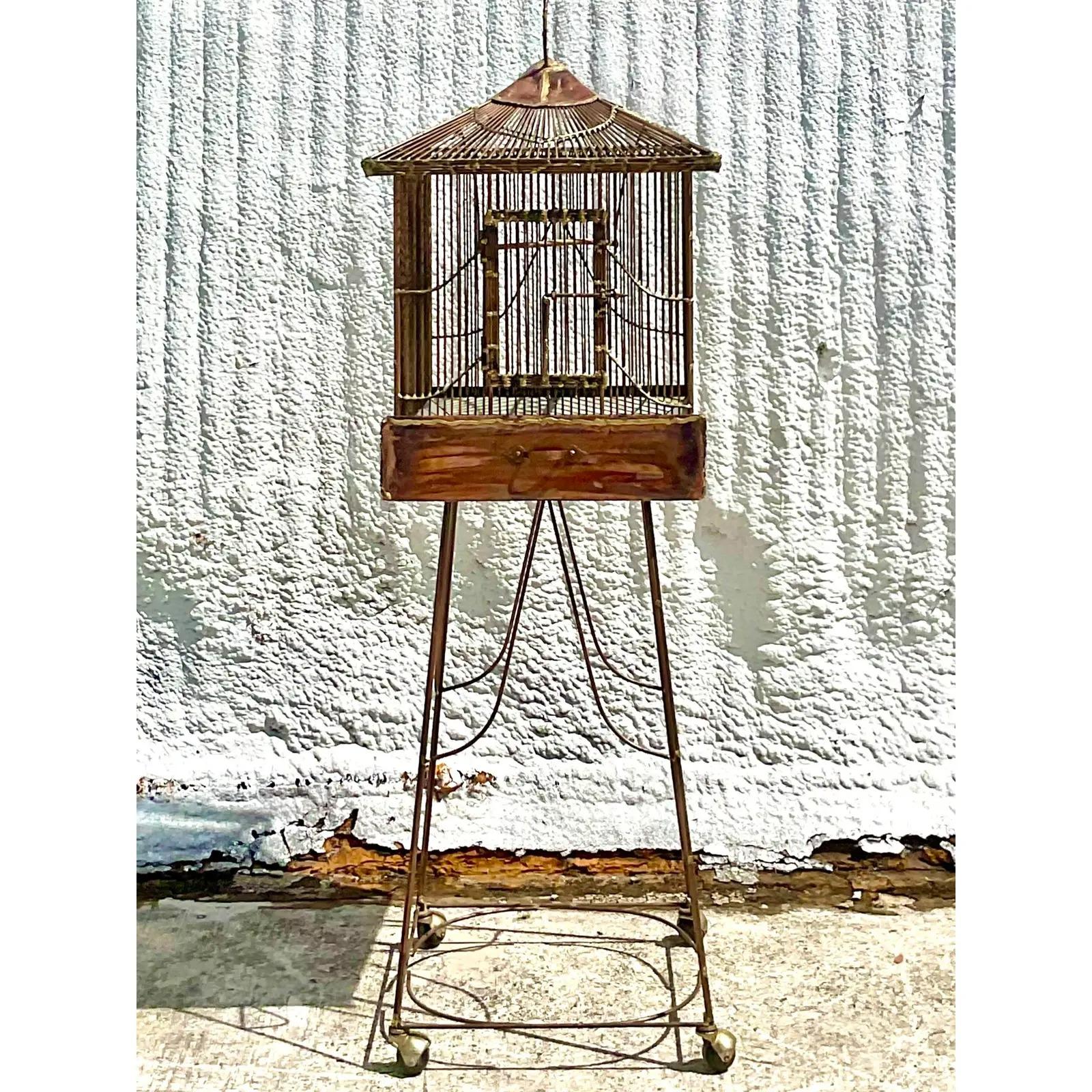 Stunning vintage Brutalist decorative birdcage. Beautiful copper construction. Sliding tray below. Rests on a copper pedestal on casters. Acquired from a Palm Beach estate.