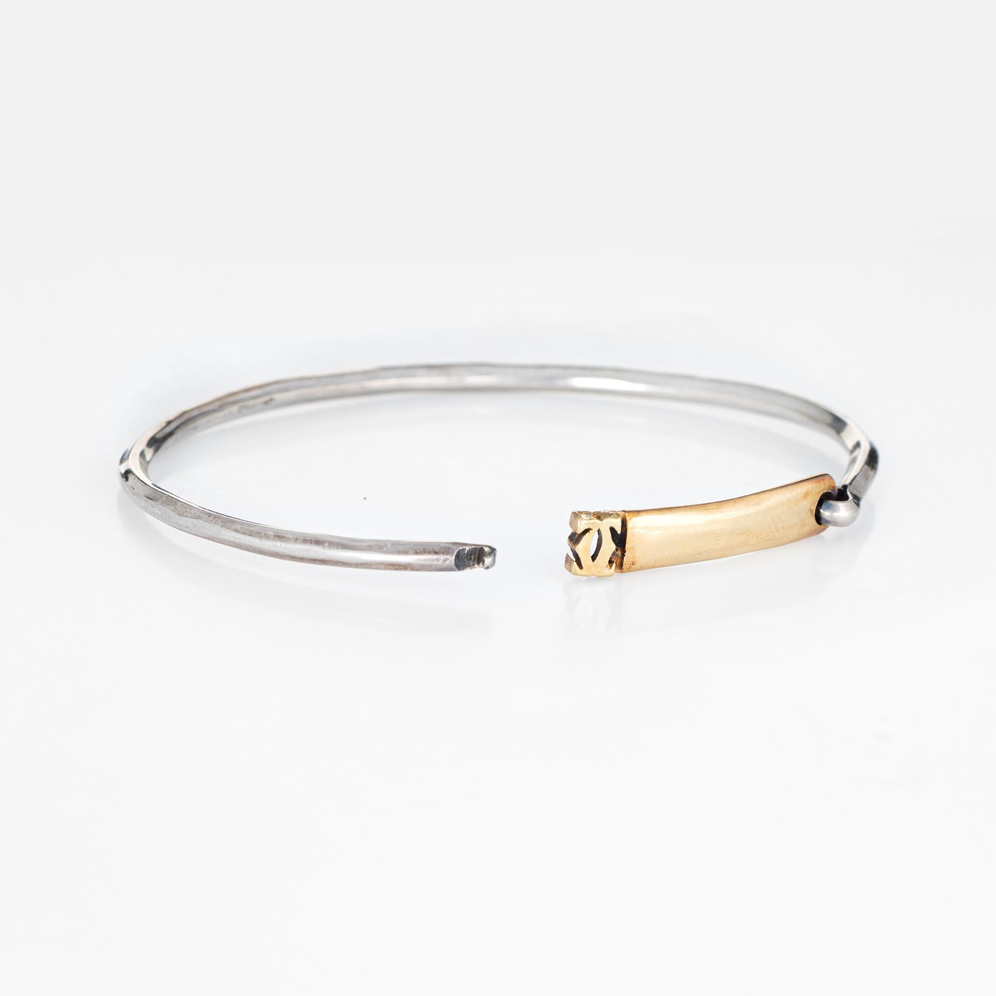 Vintage Cartier bangle bracelet crafted in sterling silver & 18 karat yellow gold (circa 1960s).  

The stylish bracelet features a 18k yellow gold bar that clips on and off to the sterling silver base. A great piece to wear alone or layer with your