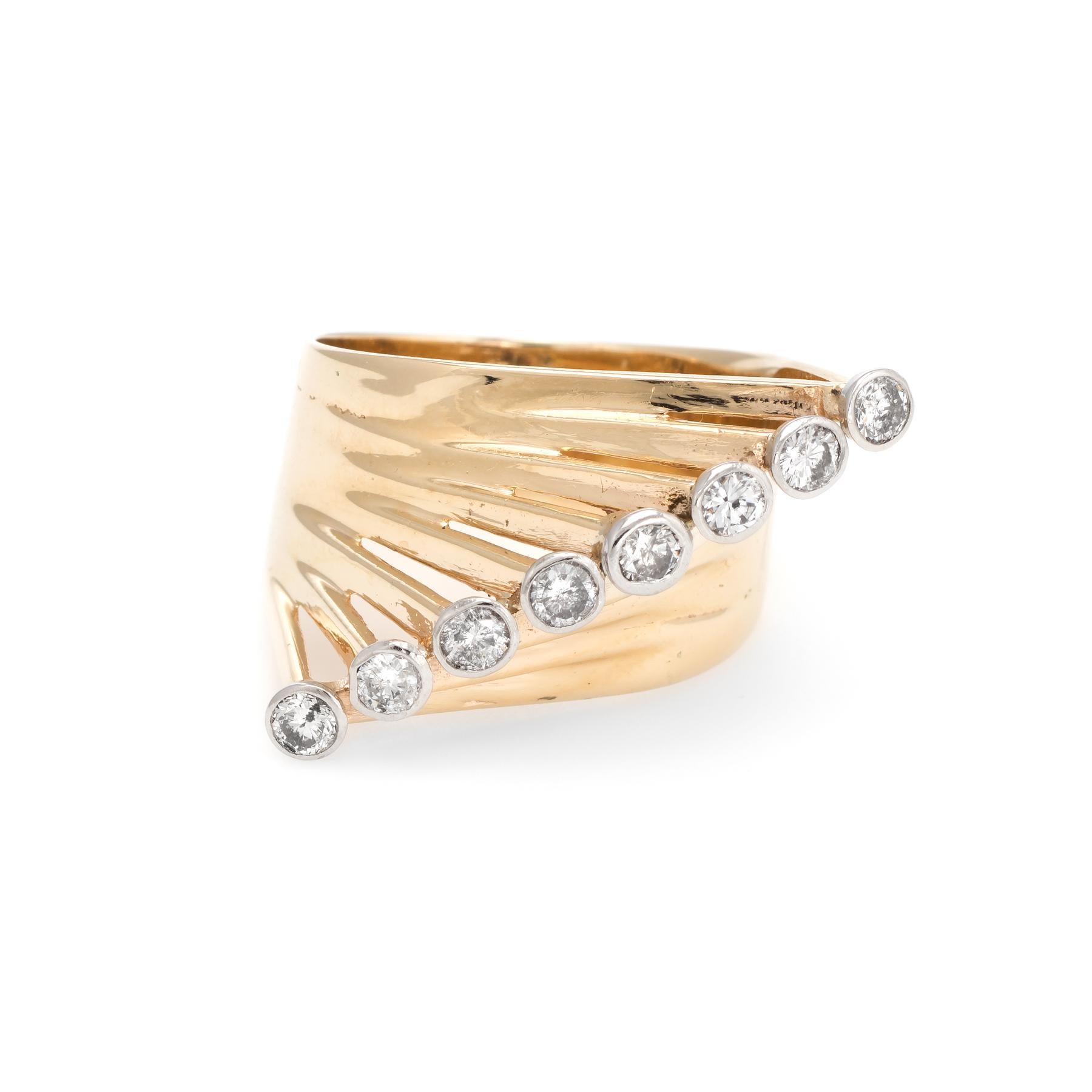 Circa 1960s, a large statement cocktail ring is crafted in 14 karat yellow gold. 

8 round brilliant cut diamonds are estimated at 0.05 carats each, totaling an estimated 0.40 carats (estimated at I-J color and I1 clarity).  

The east west design