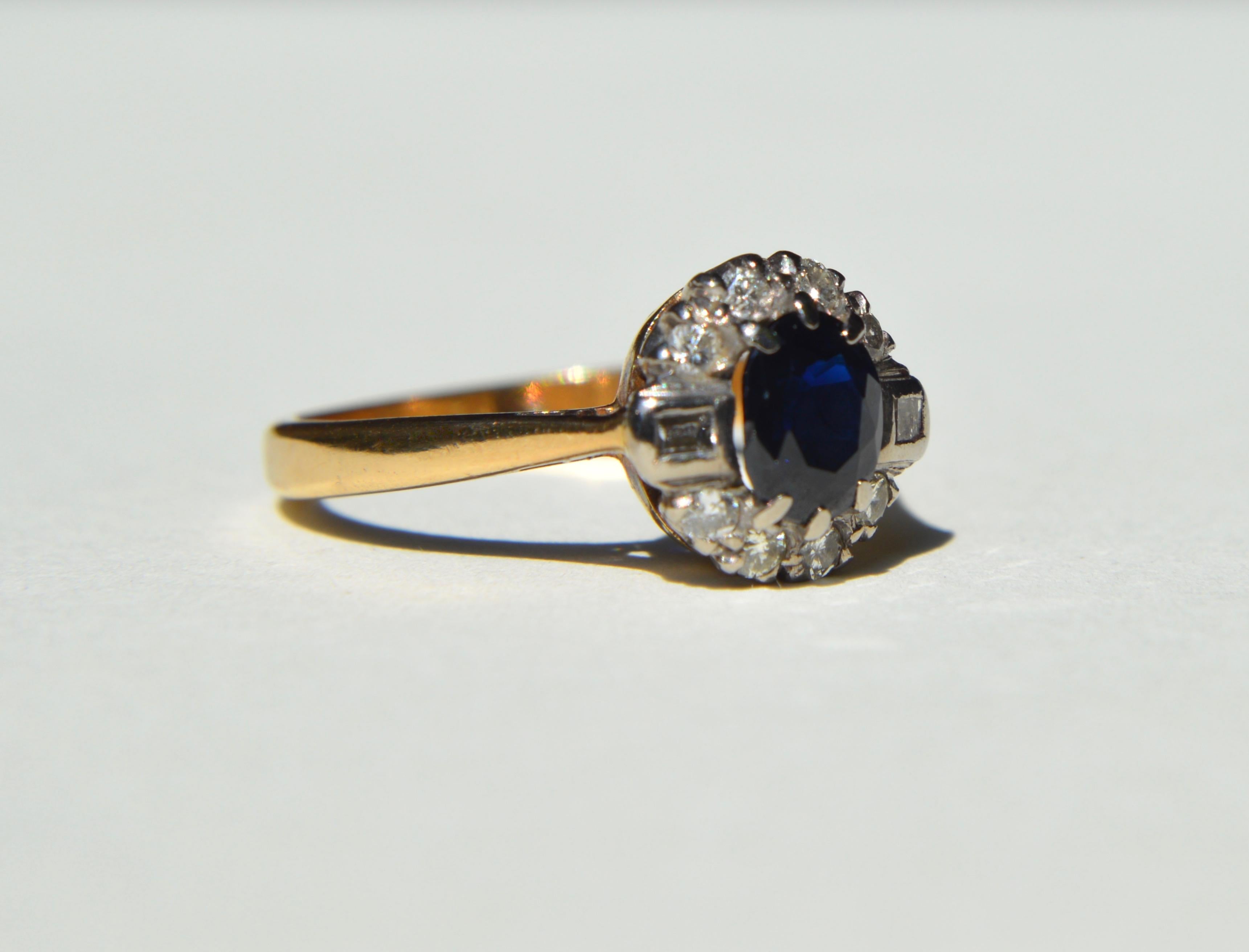 Beautiful vintage retro circa 1940s natural sapphire and diamond halo ring. 18K yellow gold. In very good condition, marked at 18K. Size 6.25, can be resized by a jeweler. Oval cut sapphire measures 6x5mm, .61 carat. Surrounded by 8 round cut