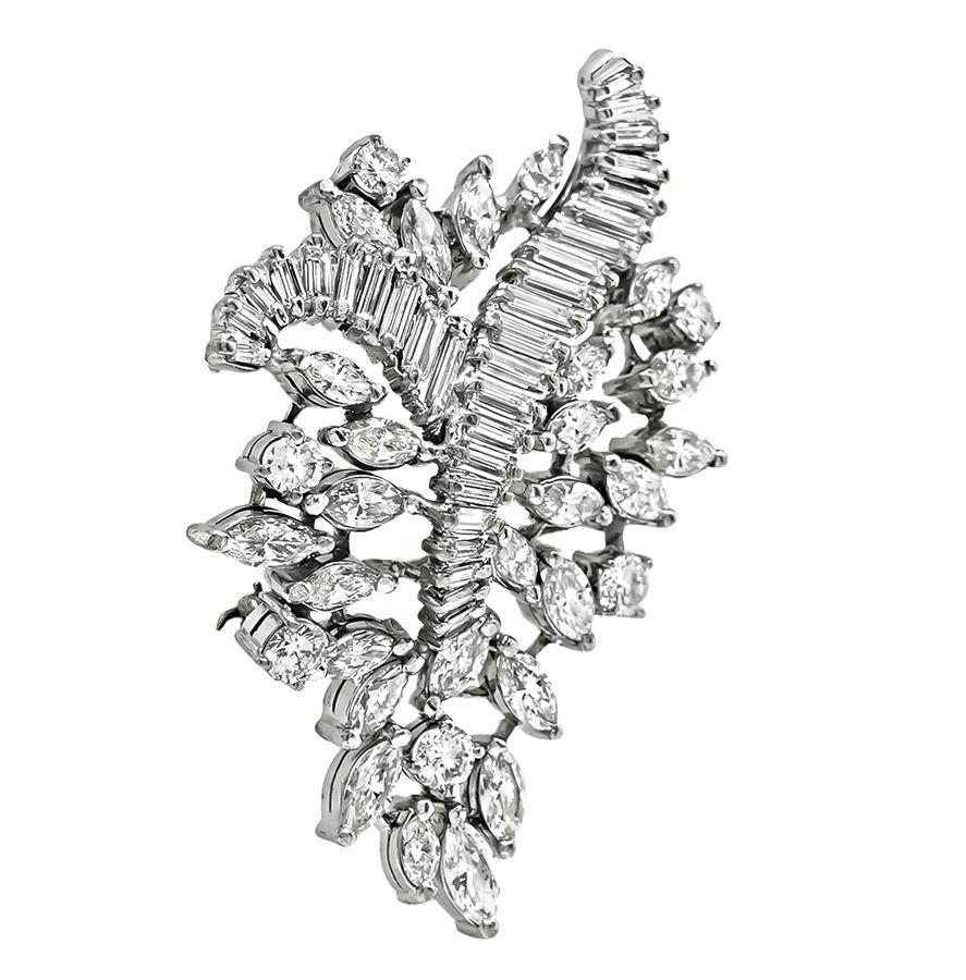 This is a magnificent 14k white gold pin from the 1950s. The pin is set with sparkling marquise, round and baguette cut diamonds that weigh approximately 6.25ct. The color of the diamonds is H-I with VS clarity. The pin measures 50mm by 34mm and