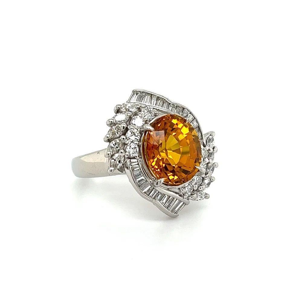 Simply Beautiful! Chic and Classic finely detailed Oval Strong Orange Sapphire and Diamond Platinum Cocktail Ring. Centering a securely nestled Hand set 6.46 Carat Fabulous Oval Strong Orange Sapphire surrounded by Diamonds, weighing approx.