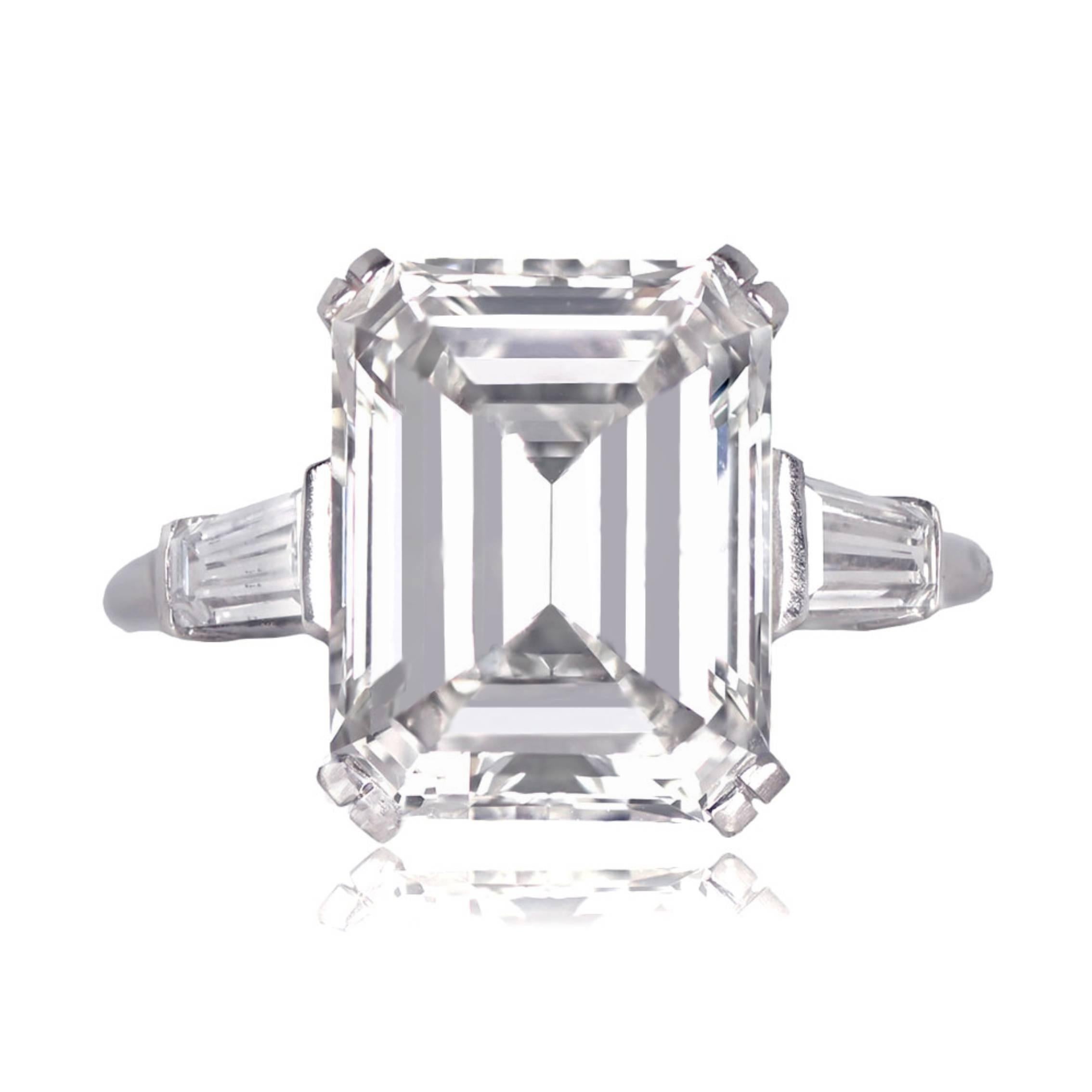 A vintage platinum engagement ring featuring a 6.49-carat emerald-cut diamond with J color and SI2 clarity. It is adorned with two tapered baguette-cut diamonds on the shoulders and dates back to approximately 1950.


Ring Size: 6.5 US,