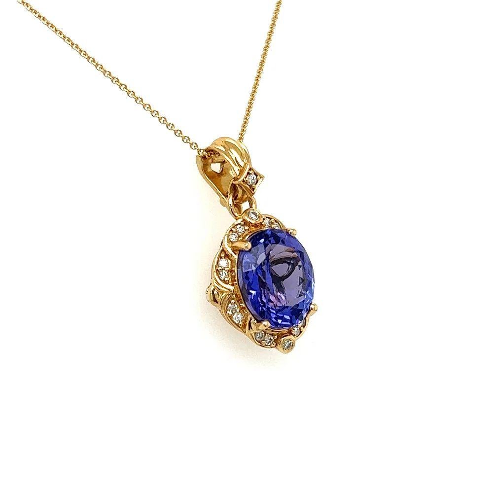 Simply Beautiful! Vintage Tanzanite and Diamond Gold Drop Pendant Necklace. Centering a securely Hand set 6.50 Carat Oval Tanzanite, accented by Diamonds, weighing approx. 0.20tcw. Suspended from a Gold Link Chain, approx. 18” long. Hand crafted 18K