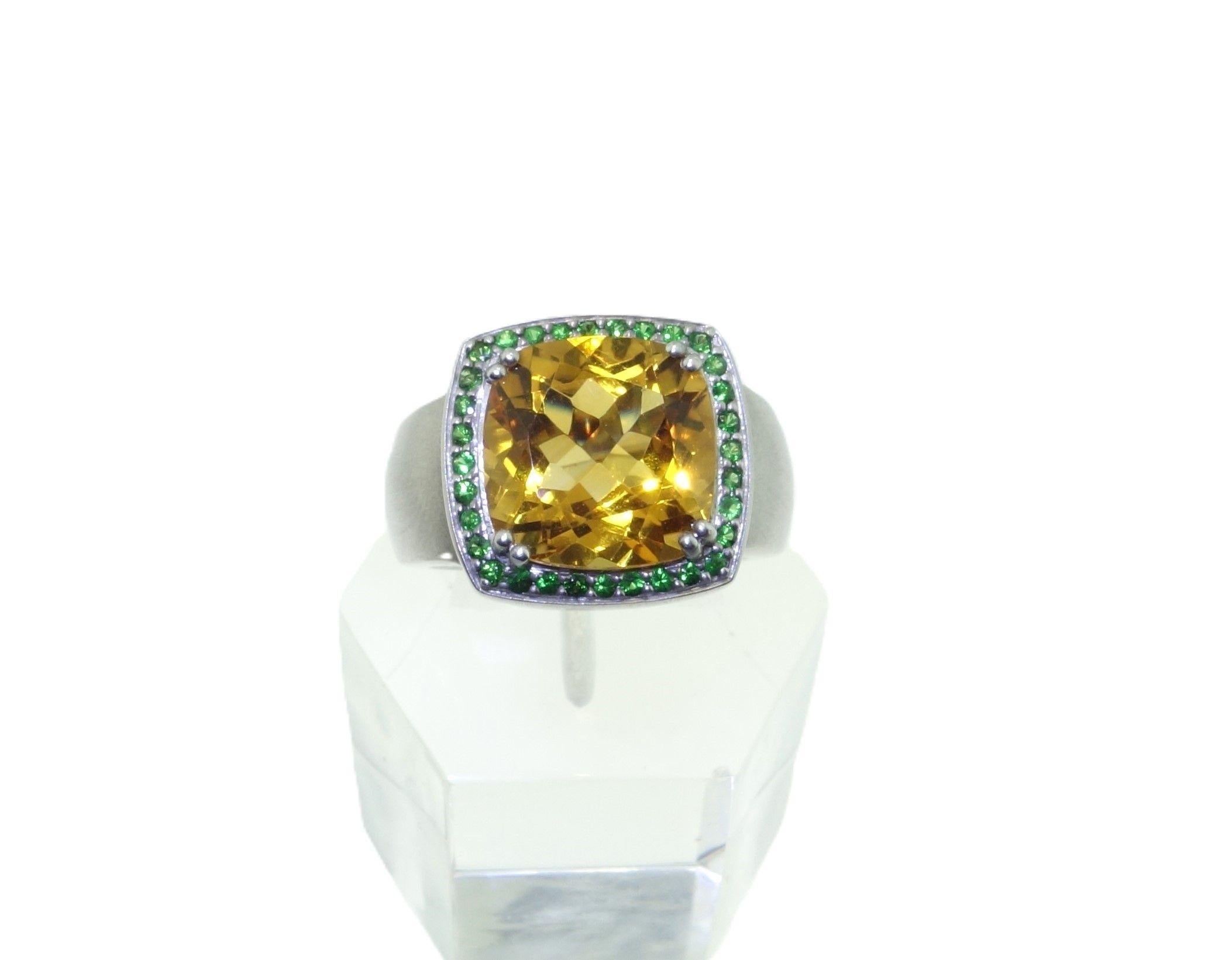 Simply Beautiful! Finely detailed 12mm Cushion Citrine and Tsavorite Sterling Silver Vintage Cocktail Ring. Centering a securely nestled Hand set 6.57 Carat Cushion Citrine, surrounded by 30 Round Tsavorite, weighing approx. 0.32tcw. Hand crafted
