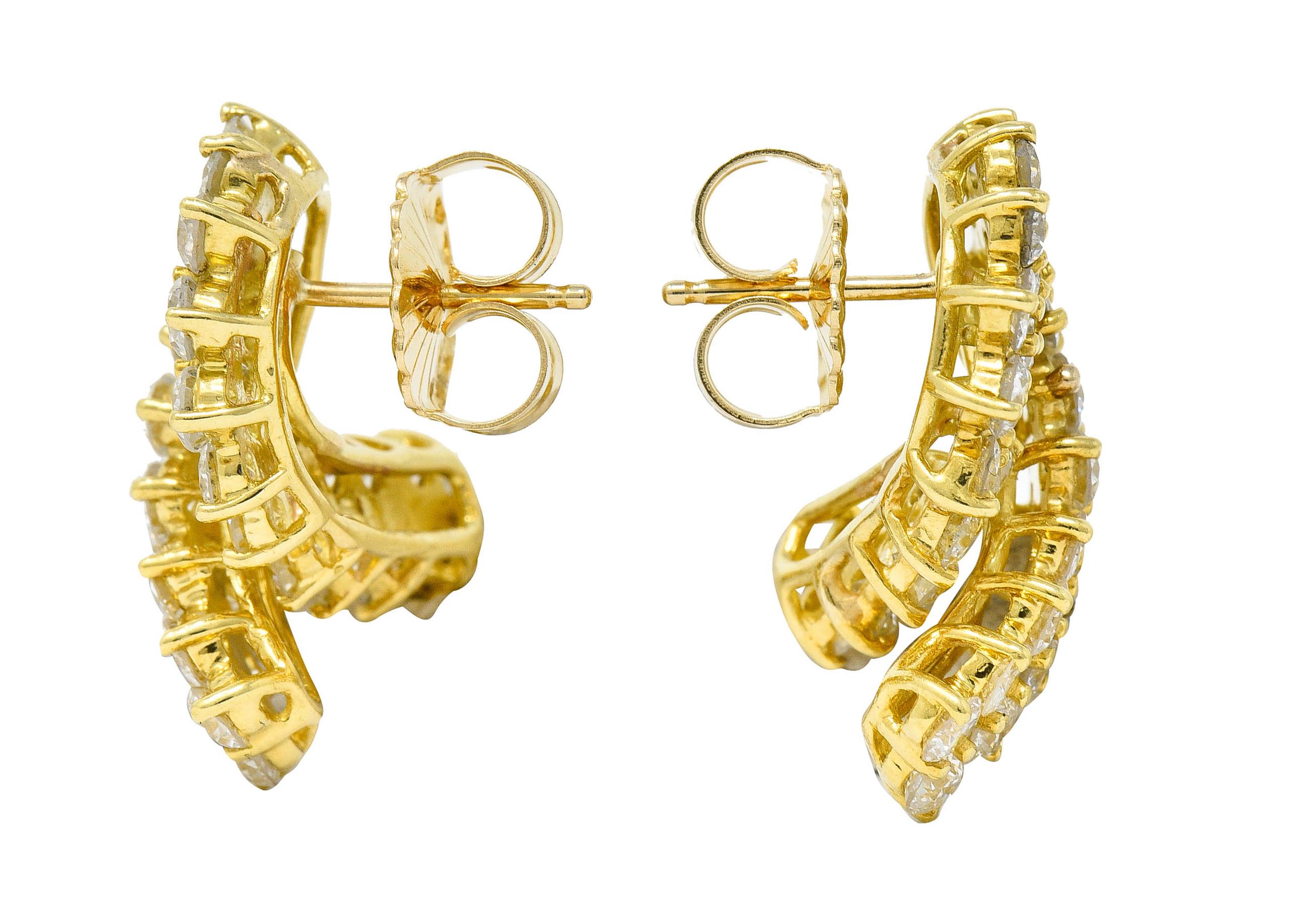 Earrings are designed as a looped ribbon

Basket set throughout by round brilliant cut diamonds

Weighing in total approximately 6.80 carats - G/H color with SI clarity

Tested as 18 karat gold

Circa: 1990s

Measures: 3/4 x 1 inch

Total weight: