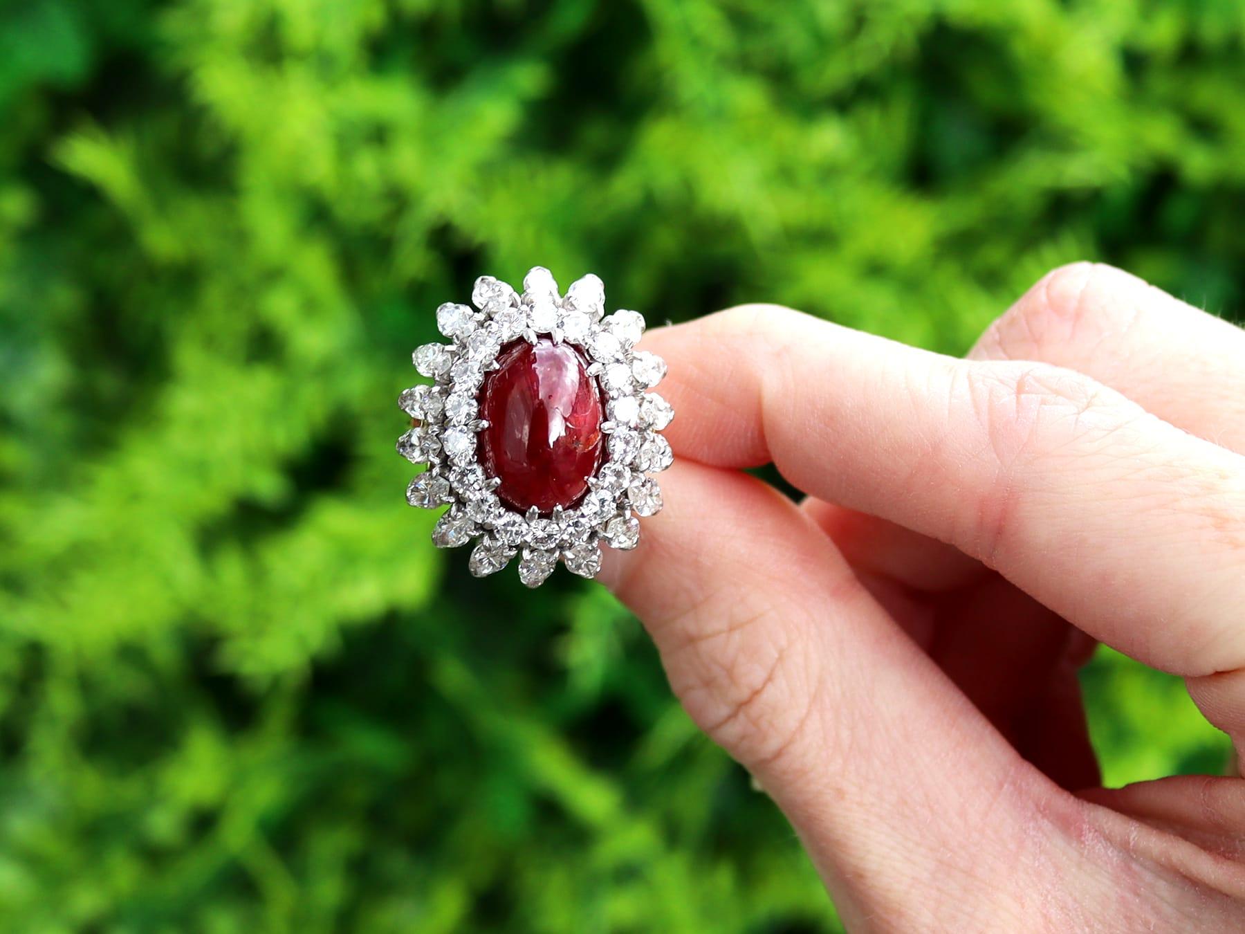 A stunning vintage 6.95 carat Cabochon Burmese ruby and 4.80 carat diamond, 18 karat yellow gold, platinum set cluster ring; part of our diverse collection of Burmese rubies.

This stunning, fine and impressive Burmese ruby and diamond ring has been