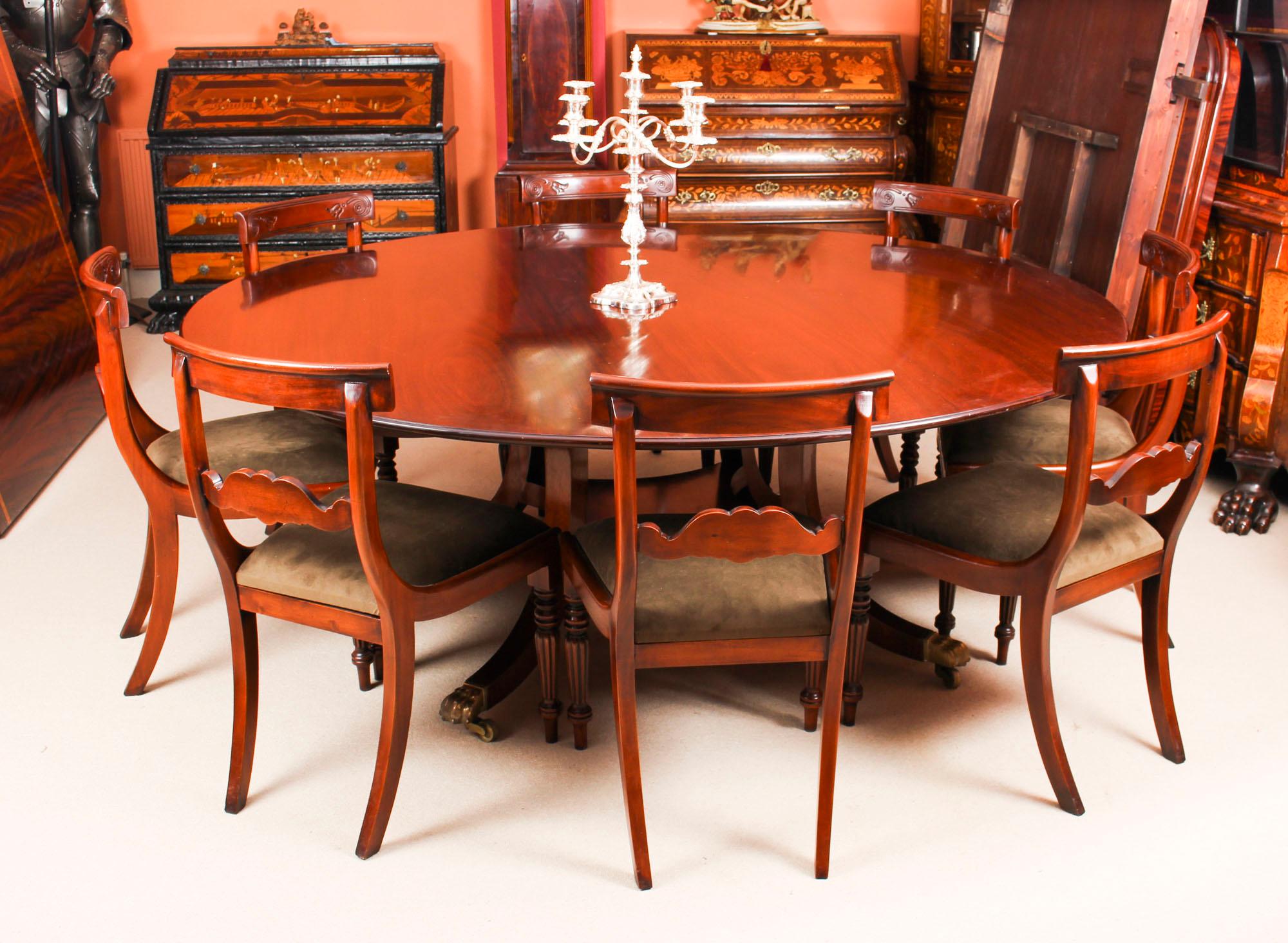 This is a beautiful dining set comprising a Regency style flame mahogany dining table made by the Master Cabinet Maker William Tillman and bearing his label on the underside, circa 1970 in date with a set of eight bespoke dining chairs.

The table