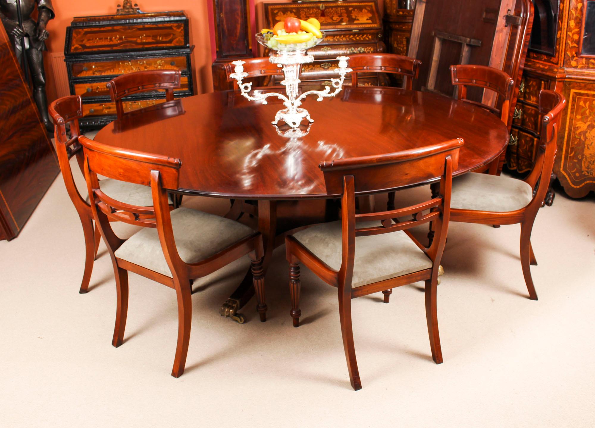 This beautiful dining set comprising a Regency style flame mahogany dining table made by the Master Cabinet maker William Tillman and bearing his label on the underside, circa 1970 in date, with a set of eight bespoke dining chairs.

The table has
