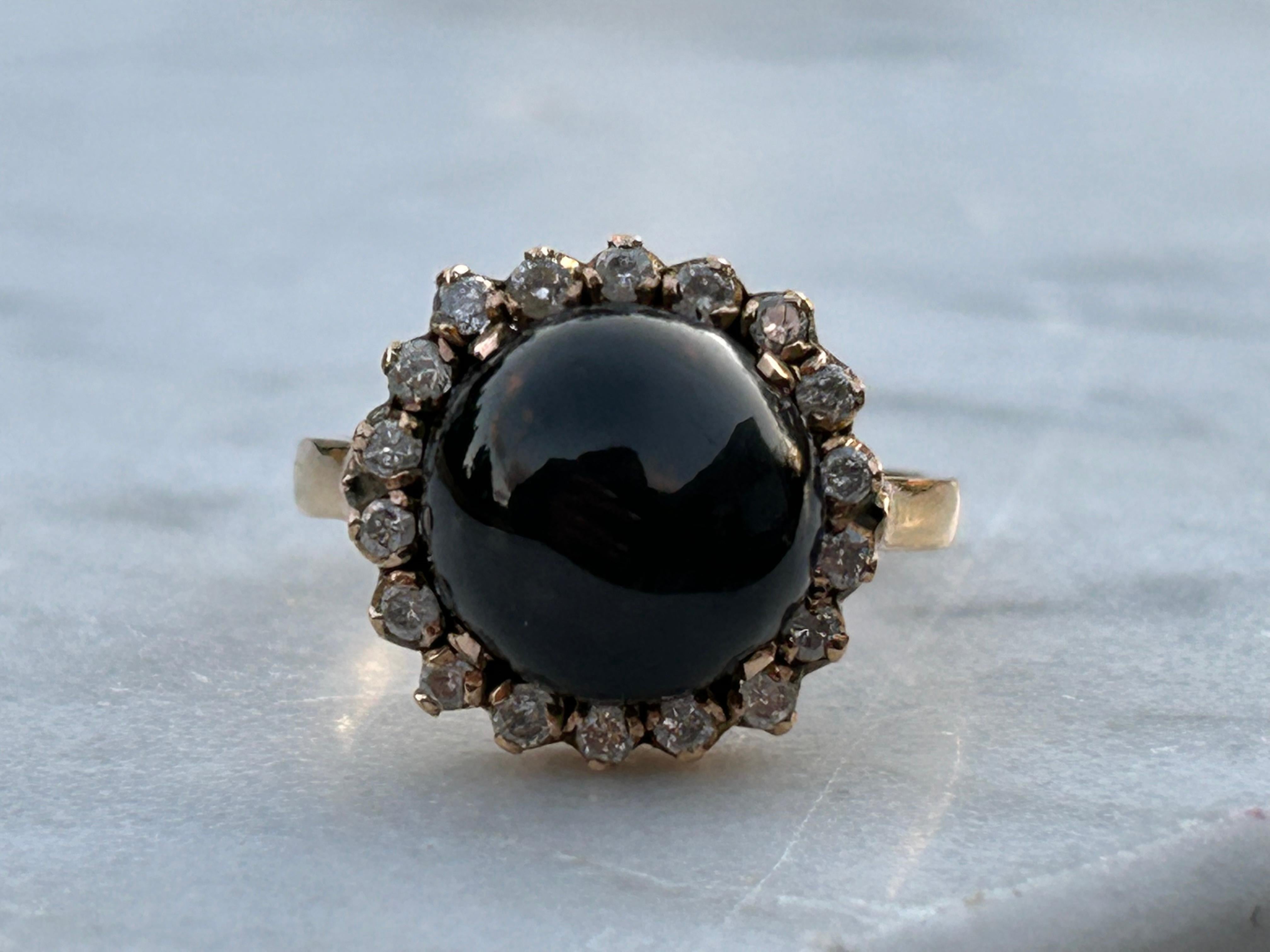 A vintage 18k gold black cabochon 4 point Star Diopside and Diamond Ring. This ring has a lovely shimmering 