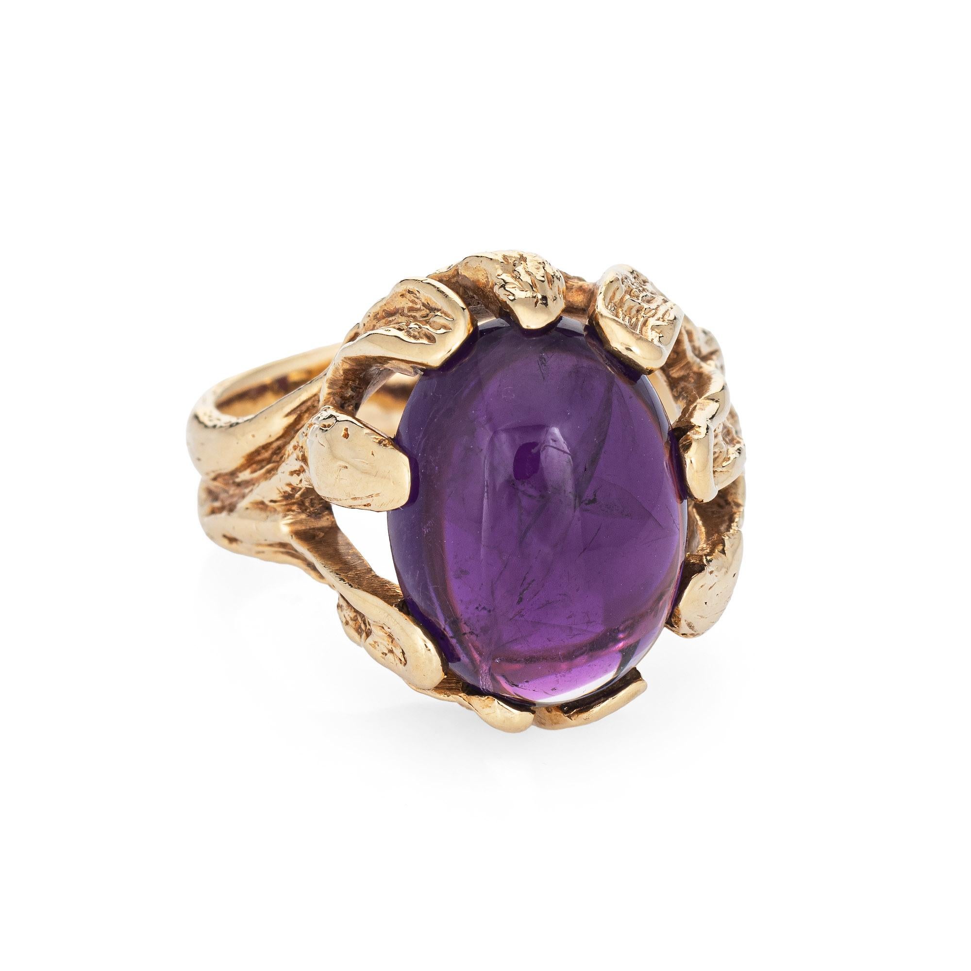Stylish vintage amethyst cocktail ring (circa 1970s) crafted in 14 karat yellow gold. 

Cabochon cut amethyst measures 17mm x 12.5mm (estimated at 10 carats). The amethyst is in very good condition and free of cracks or chips. Twelve lapis beads
