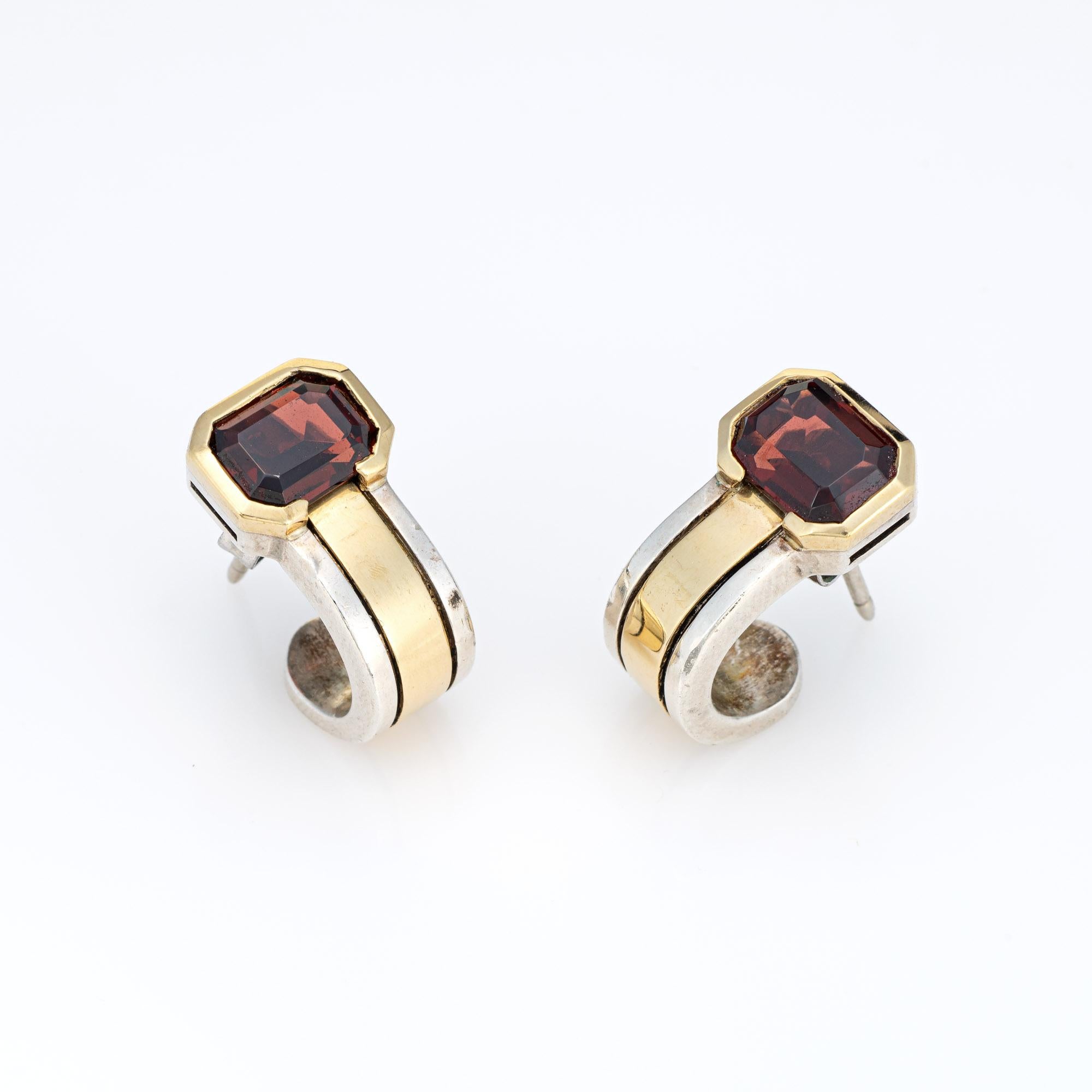 Stylish vintage Cartier garnet earrings crafted in sterling silver and 18 karat yellow gold (circa 1970s).  

Two garnets each measure 7.5mm x 5.5mm. The garnets are in very good condition and free of cracks or chips.
Designed in the Art Deco style,