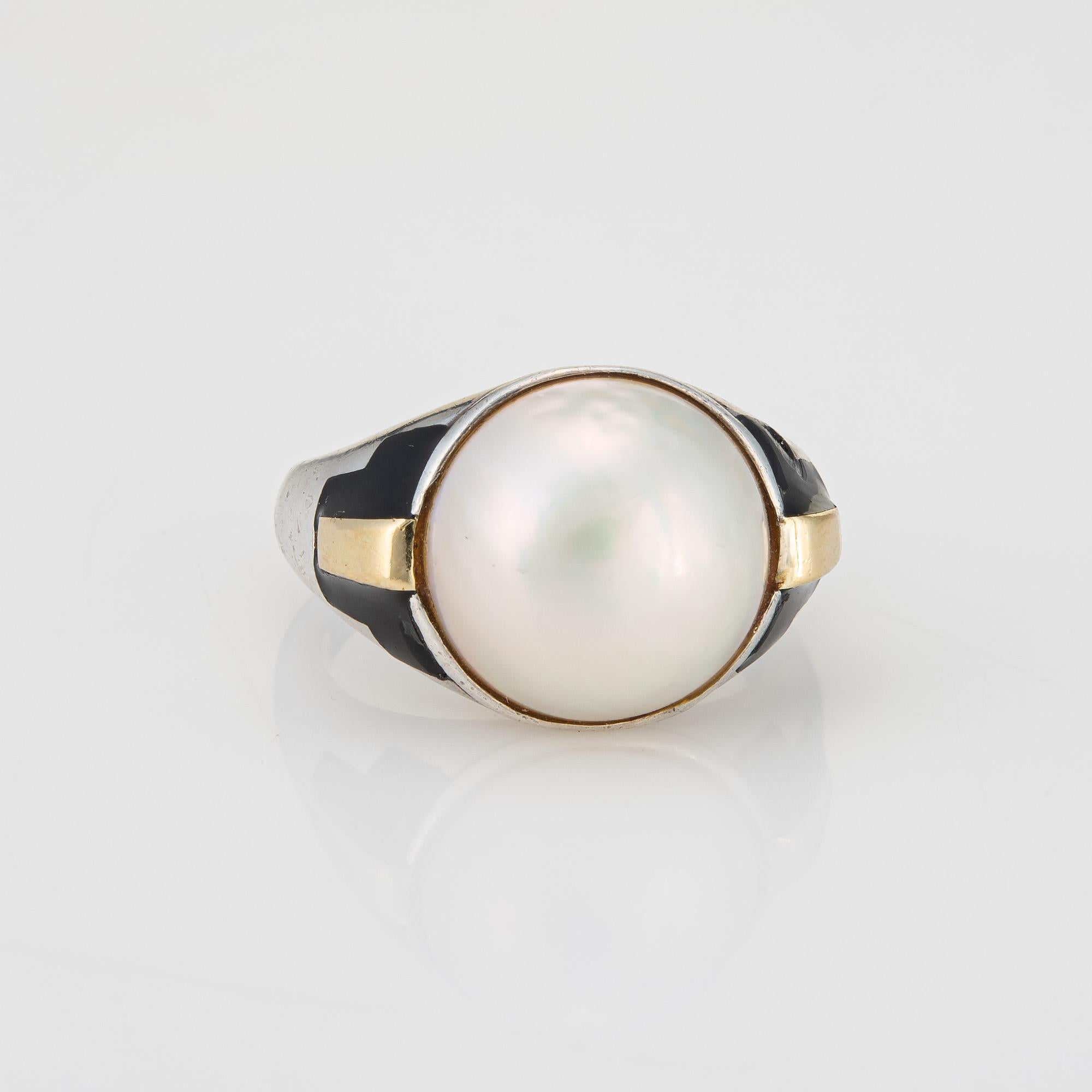 Stylish vintage Cartier Mabe pearl ring crafted in sterling silver and 18 karat yellow gold (circa 1970s).  

One 12.5mm Mabe pearl is set into the ring. The pearl exhibits a glossy luster with rose & green overtones. 
Designed in the Art Deco