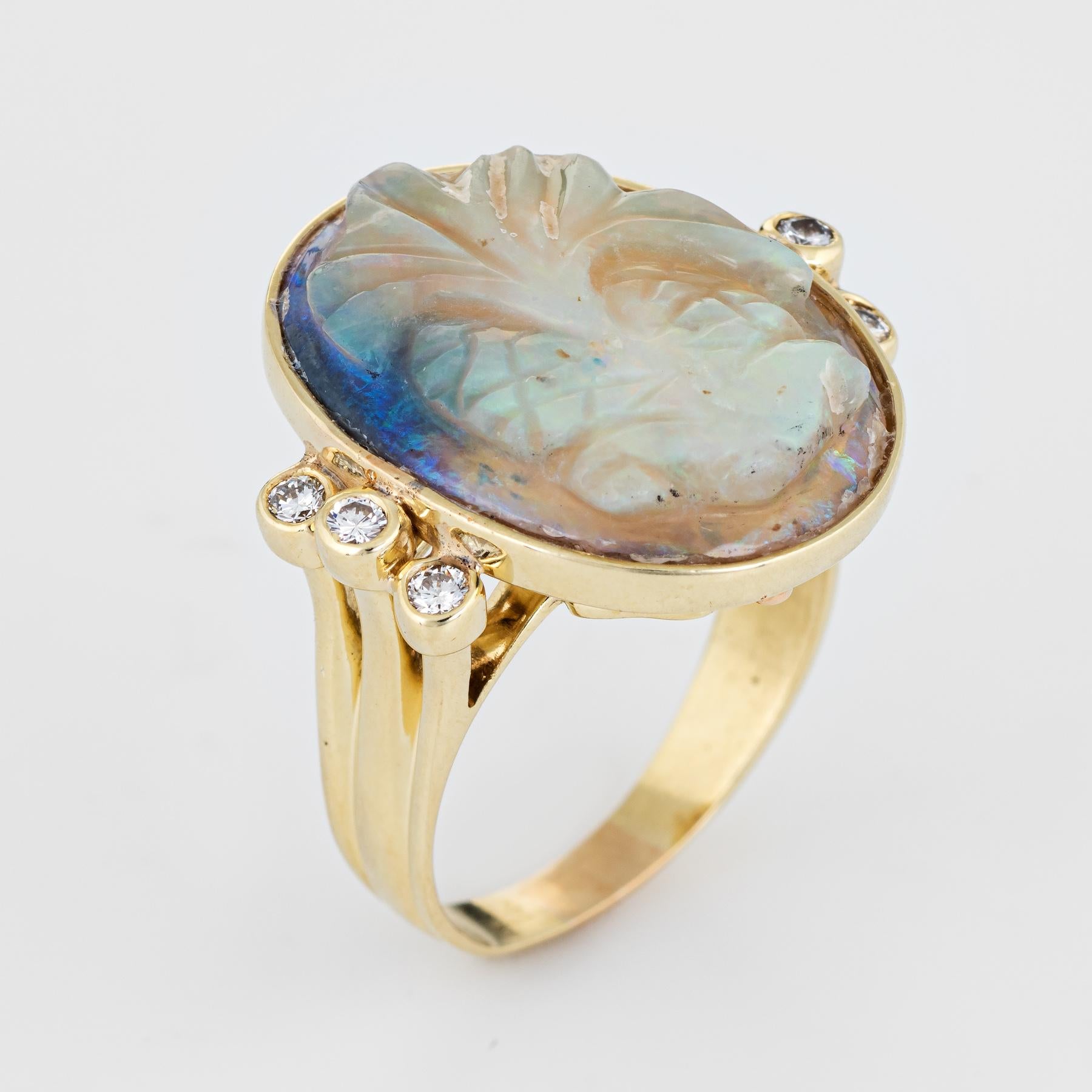 Finely detailed vintage carved opal & diamond ring (circa 1970s), crafted in 14 karat yellow gold. 

One oval piece of natural opal is carved in the form of a Palm Tree (measuring 20mm x 16mm). The opal is in excellent condition and free of cracks