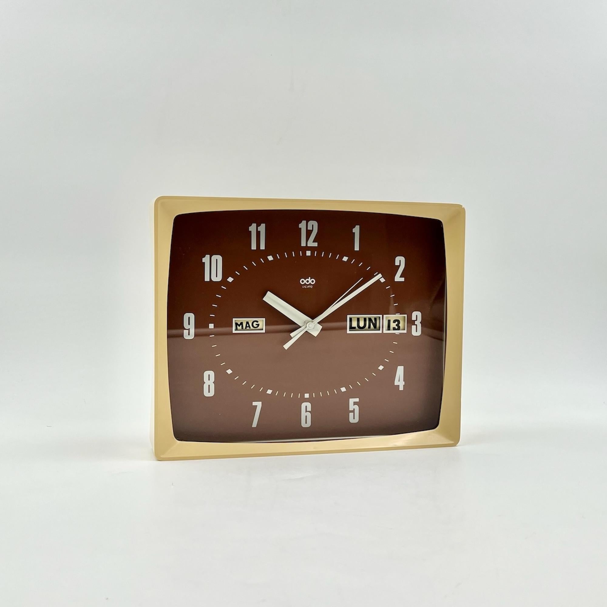 Step back in time in the realm of 70’s clocks with this amazing vintage wall clock featuring a flip calendar, produced by ODO Clock in France during the 1970s. Crafted with space age aesthetics in mind, this clock boasts a thick glossy cream plastic
