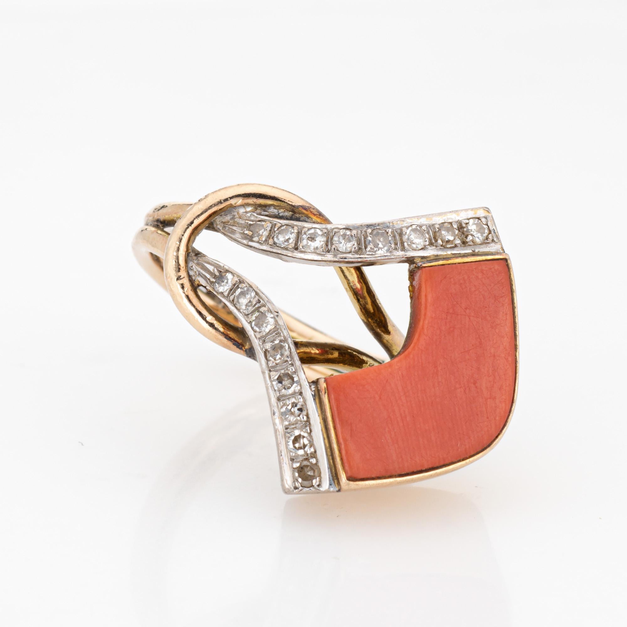 Finely detailed vintage coral & diamond cocktail ring, crafted in 14 karat yellow gold (circa 1970s). 

One piece of salmon hued coral measures 15mm x 6mm. 16 single cut diamonds total an estimated 0.10 carats (estimated at H-I color and SI1-I2