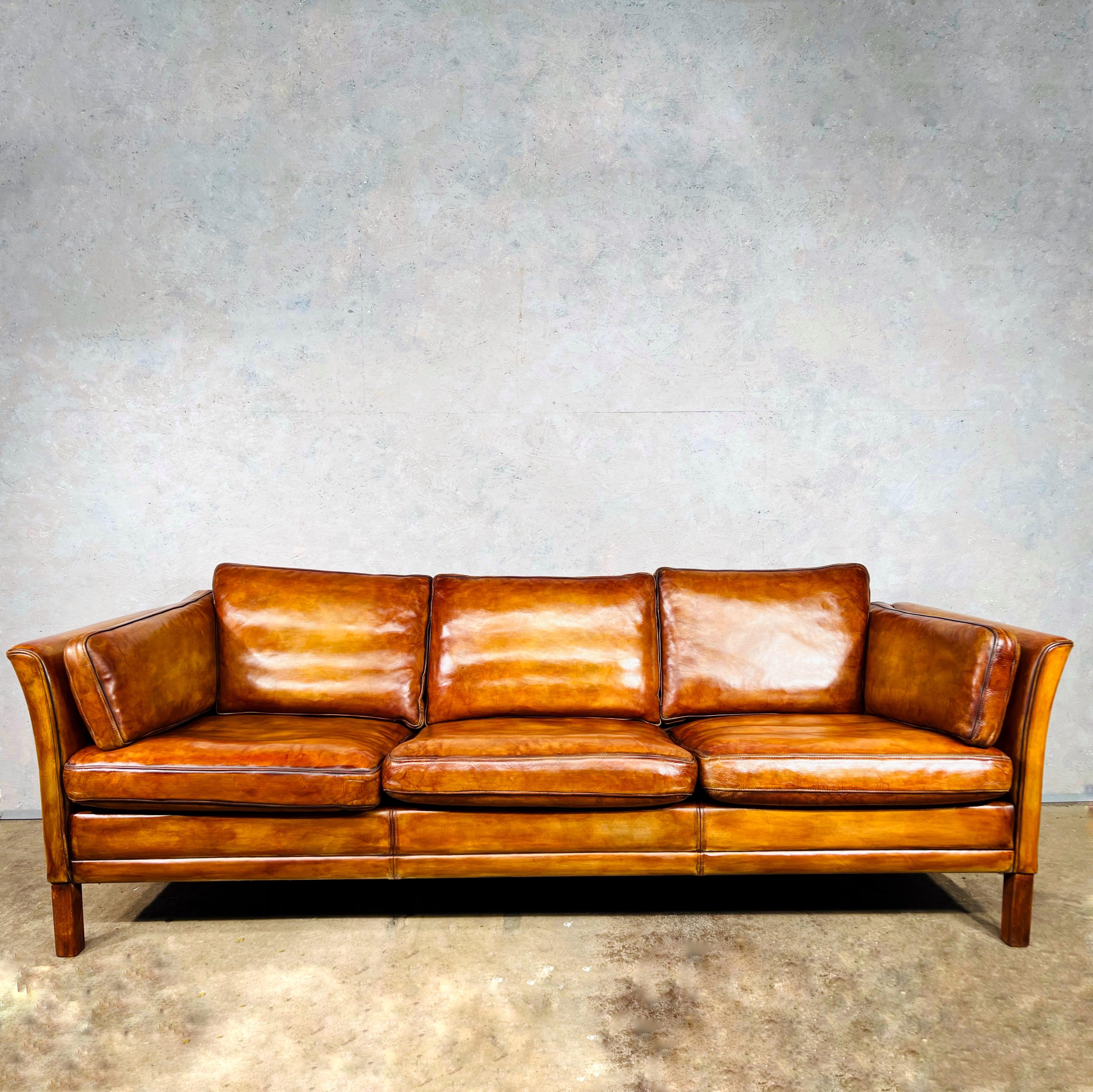 A Stylish Vintage 70s 3 seater leather sofa by Danish designer Mogens Hansen in a Patinated Light Tan colour
Great design with beautiful lines. Great size made with high quality leather.

The leather is a Stunning hand dyed Light Tan colour and