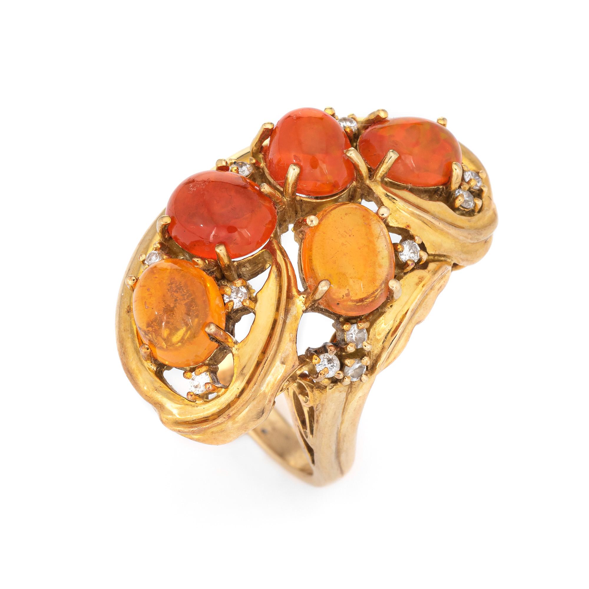 Stylish vintage Mexican fire opal & diamond cocktail ring (circa 1970s) crafted in 18 karat yellow gold. 

Five natural opals range in size from 6mm to 7mm (estimated at 4.68 carats) is accented with eight round brilliant cut diamonds totaling an