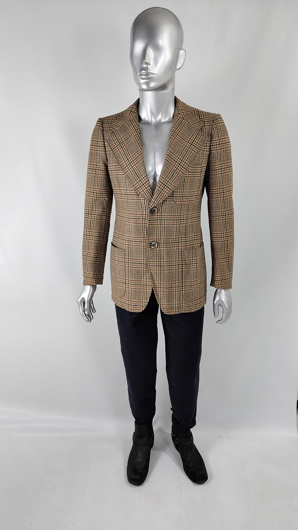 A stylish and high quality vintage mens blazer / sport coat from the 1970s. Made from a wool tweed with a plaid check throughout, it has super wide lapels, large patch pockets and double vents to the rear, adding a flamboyant flair to the classic