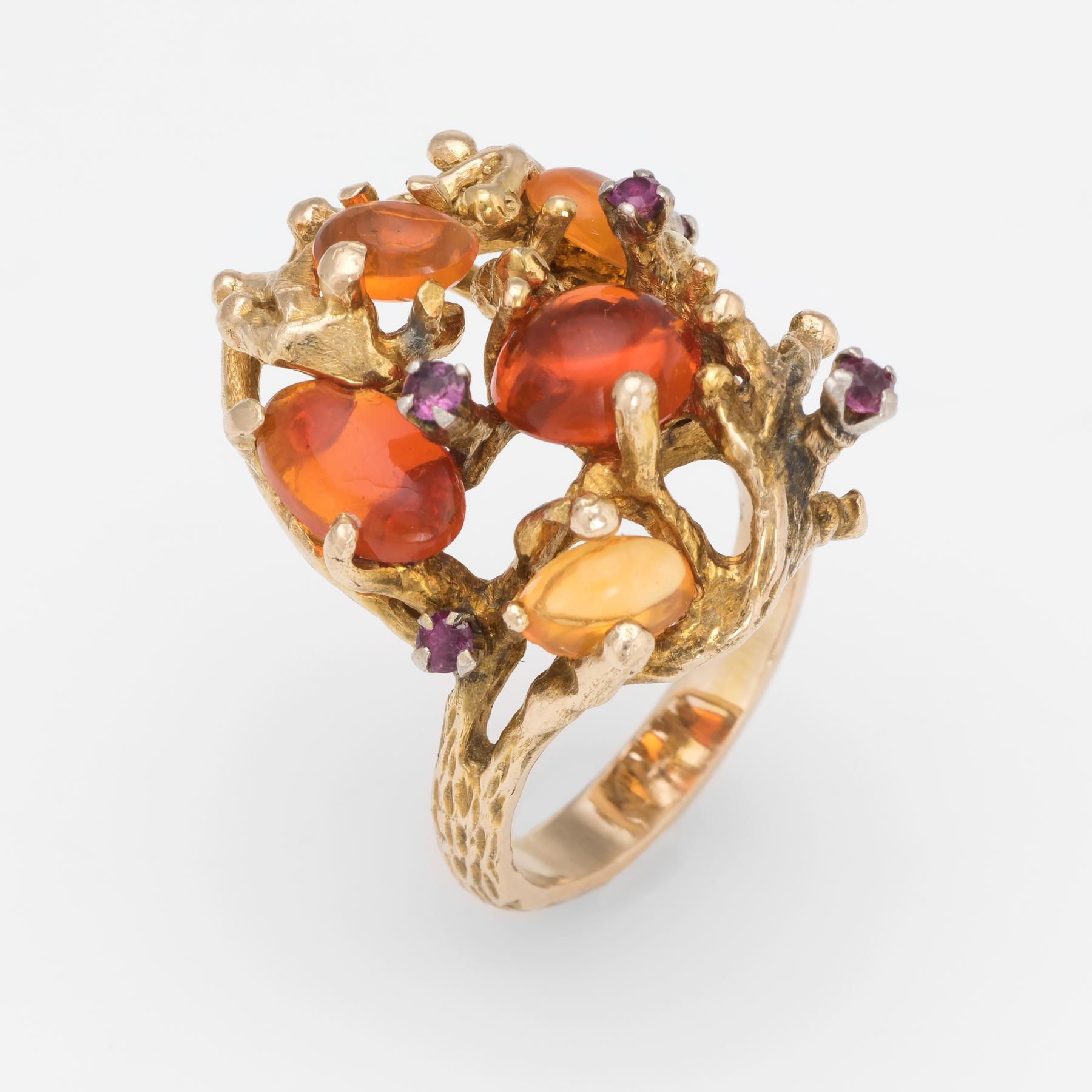 Finely detailed vintage Mexican fire opal and ruby ring (circa 1970s), crafted in 14 karat yellow gold. 

Mexican fire opals range in size from 0.40 to 1.50 carats. The total opal weight is estimated at 4 carats. The 5 rubies total an estimated 0.10
