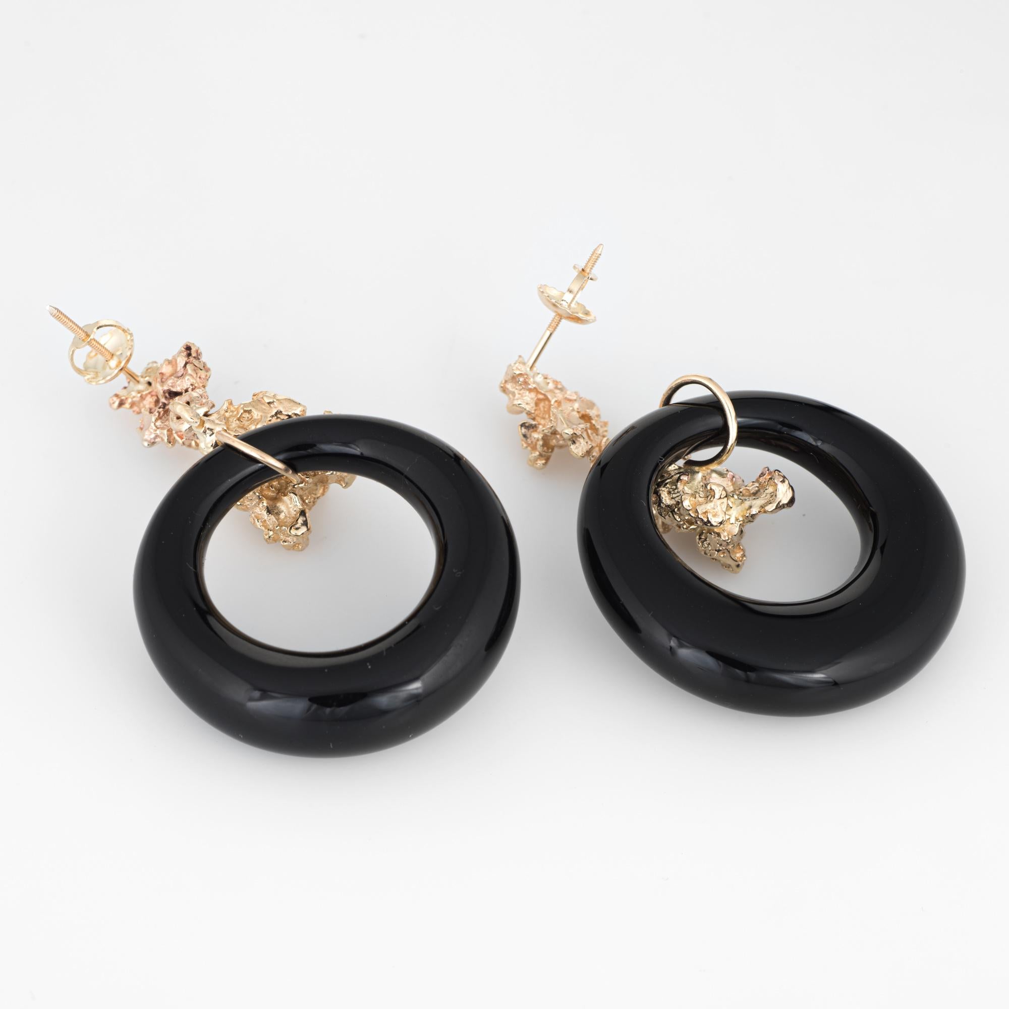 Elegant pair of vintage onyx hoop earrings (circa 1970s) crafted in 14k yellow gold. 

Onyx hoops measure from 4mm to 7.5mm. The onyx is in excellent condition and free of cracks or chips. 

The onyx is supported by freeform gold nuggets (14k gold).