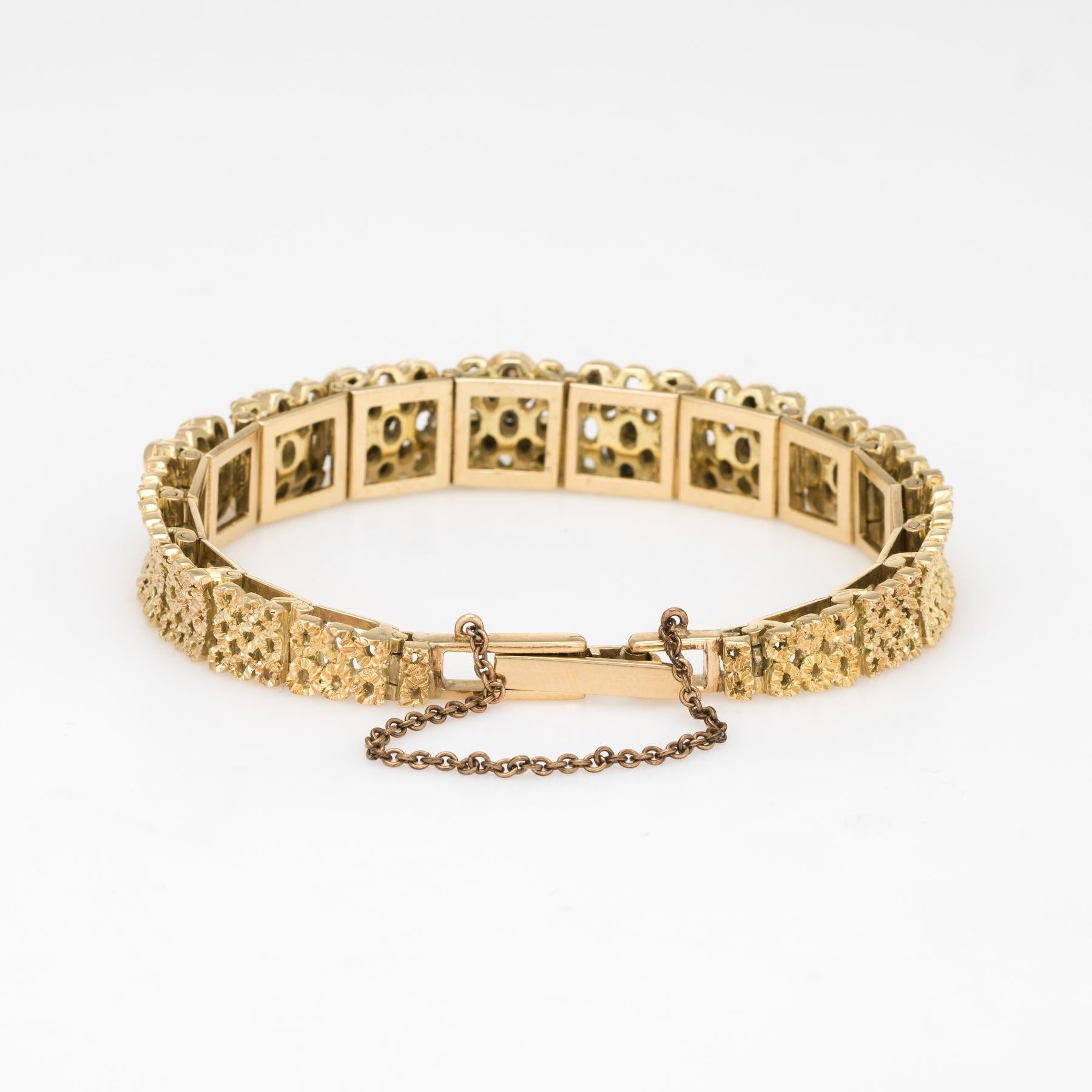 Stylish and finely detailed vintage opal bracelet (circa 1970s), crafted in 14 karat yellow gold. 

21 natural opals measure (average) 3mm (estimated at 0.10 carats each - 2.10 carats total estimated weight), accented with 7 estimated 0.01 carat