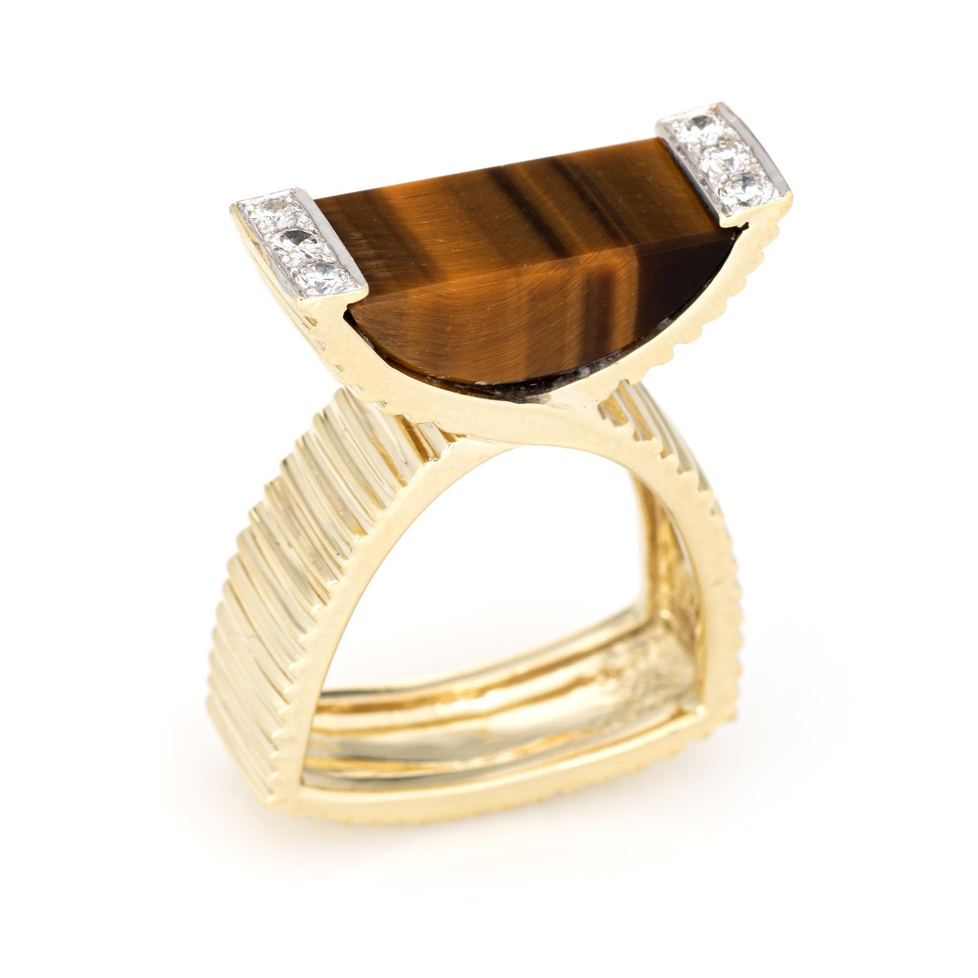Stylish vintage tigers eye & diamond ring (circa 1970s) crafted in 14 karat yellow gold. 

Tigers eye measures 16mm x 8mm, accented with six diamonds totaling an estimated 0.30 carats (estimated at G-H color and VS2 clarity). The tigers eye is in