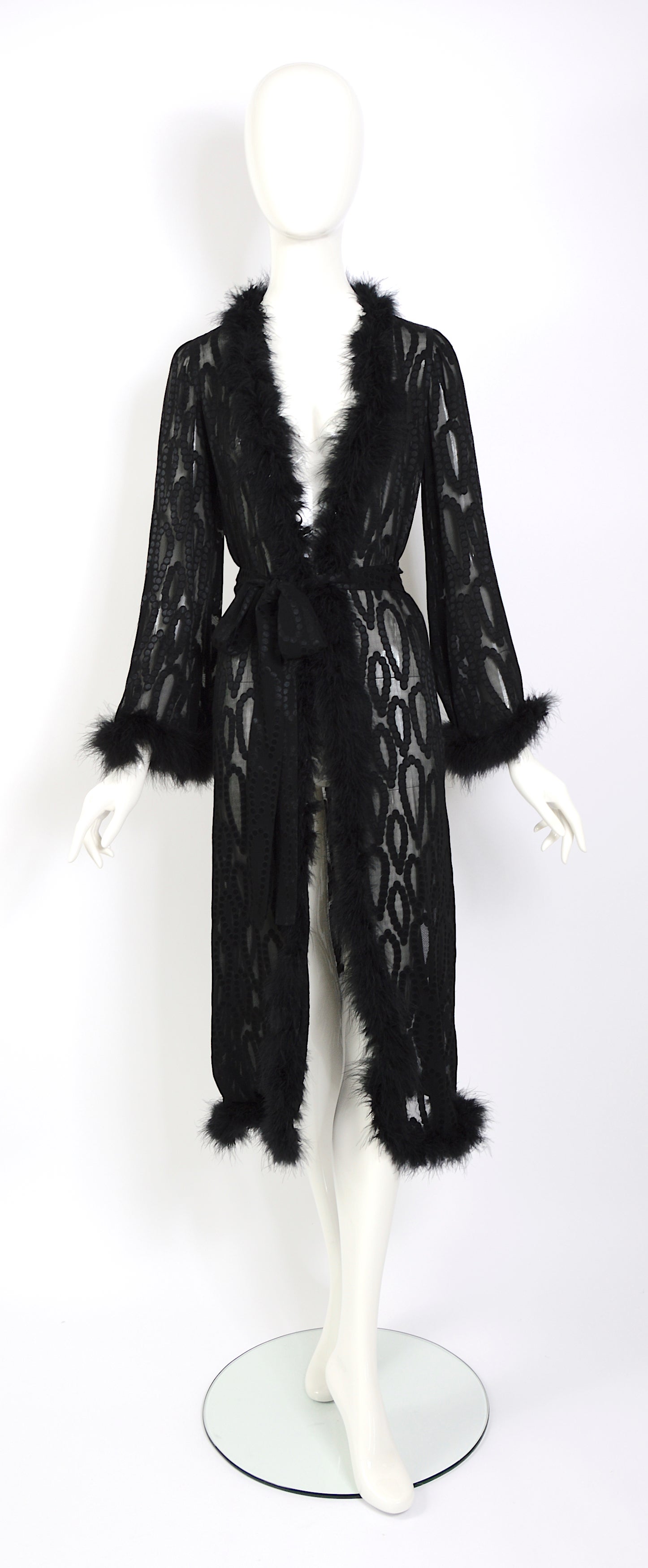 Vintage rare one-of-a-kind 1970s Yves Saint Laurent “rive gauche” black dotted silk trimmed with marabou feather-light evening robe or coat.
This YSL robe or coat is certainly a statement piece that would have been very fashionable in the 1970s and