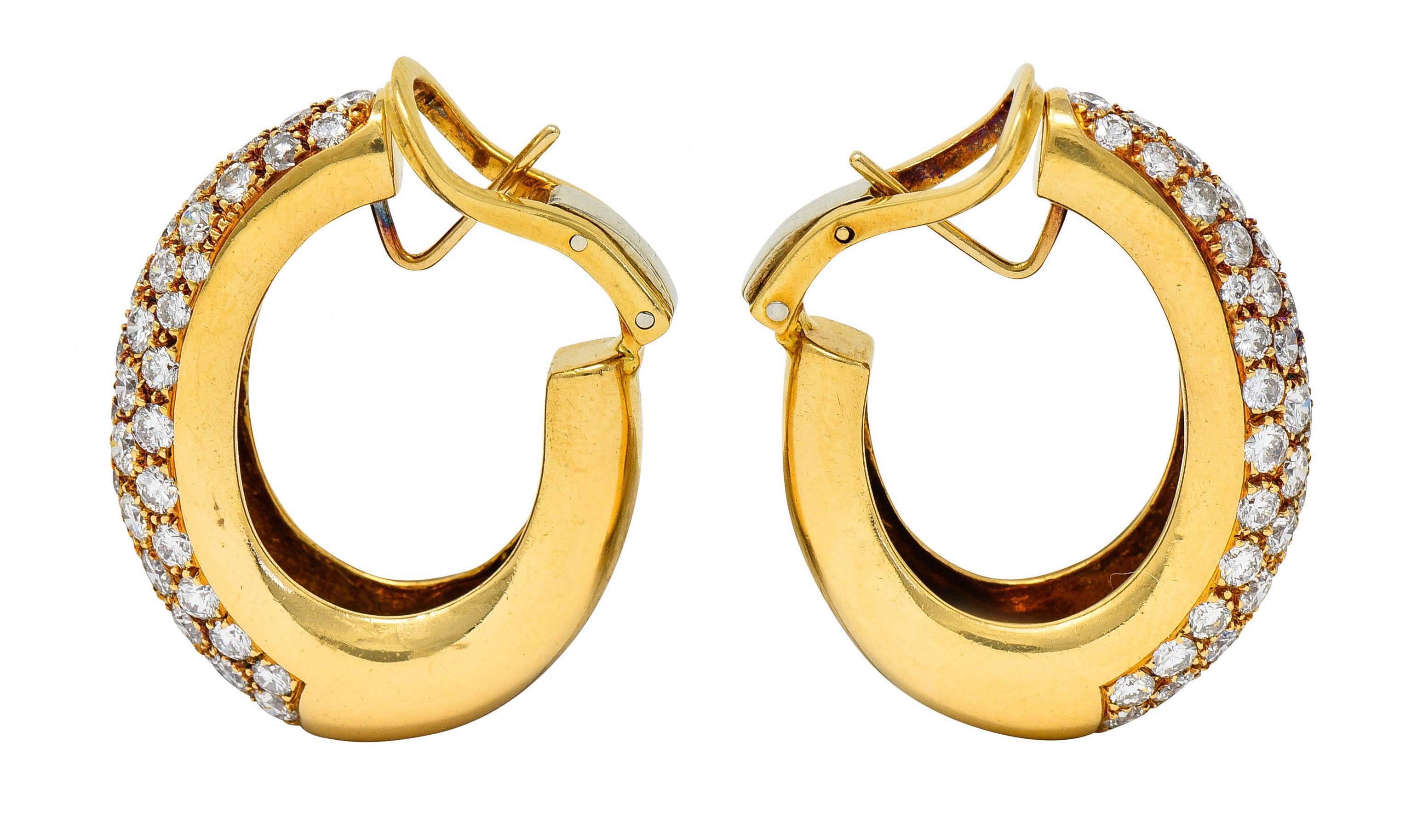 Puffed hoop earrings are pavè set to front with round brilliant cut diamonds

Weighing in total approximately 7.45 carats with G to J color with SI clarity

Completed by posts and hinged omega backs

Tested as 18 karat gold

Circa: 1980s

Measures: