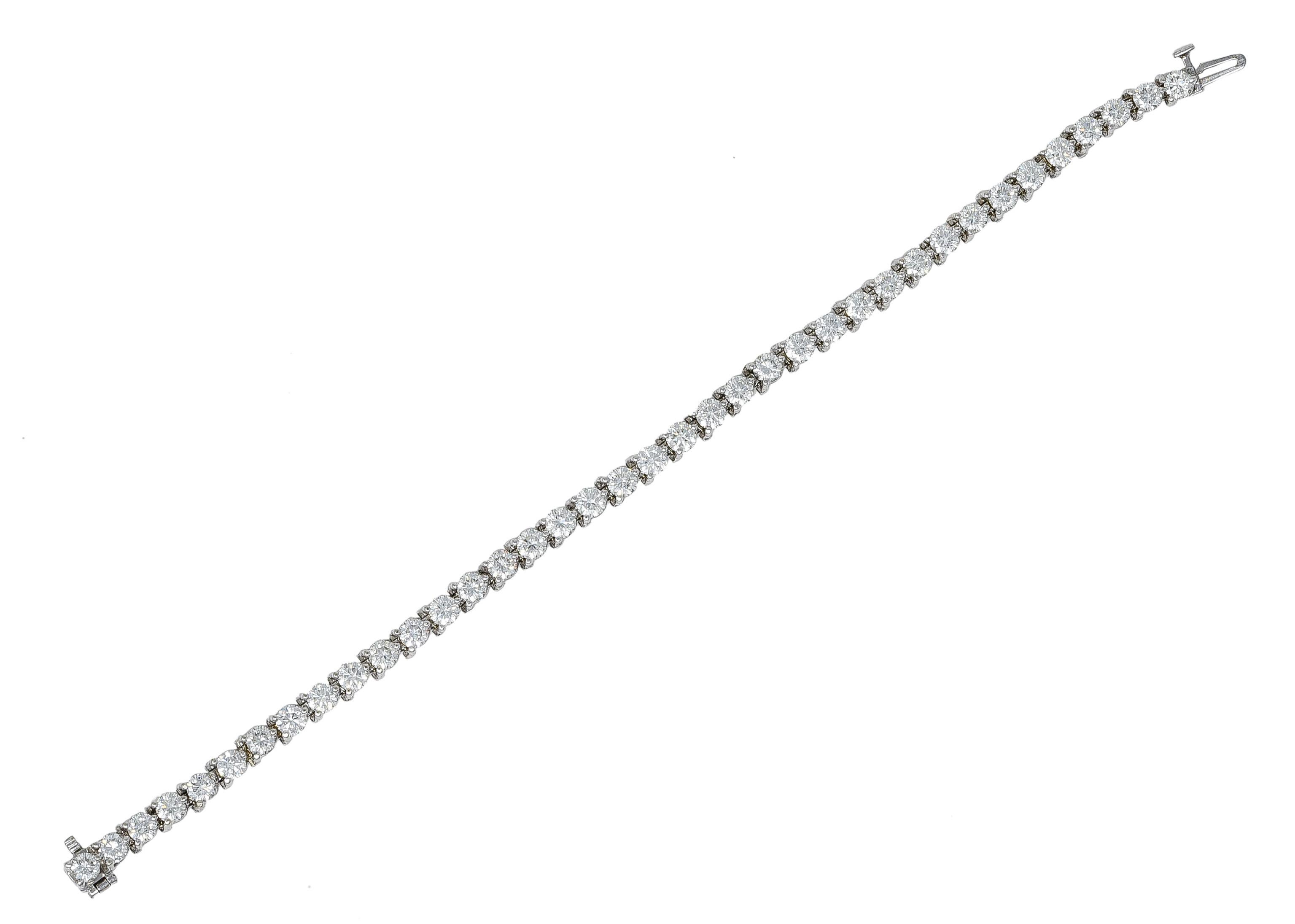 Tennis bracelet is comprised of individually articulated links. Each basket set with a round brilliant cut diamond via martini prong. Weighing in total approximately 7.50 carats. With G/H color; primarily VS2 clarity and some SI1. Completed by a