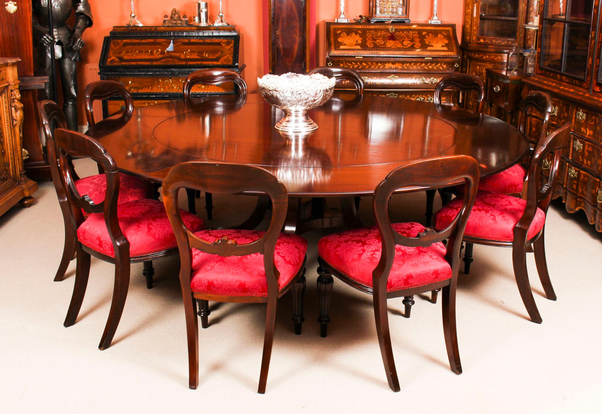 This fantastic dining set comprises a Regency Revival Jupe style flame mahogany dining table by William Tillman, circa 1970 in date and a set of ten antique Victorian balloon back dining chairs, circa 1850 in date.

The beautiful Regency Revival