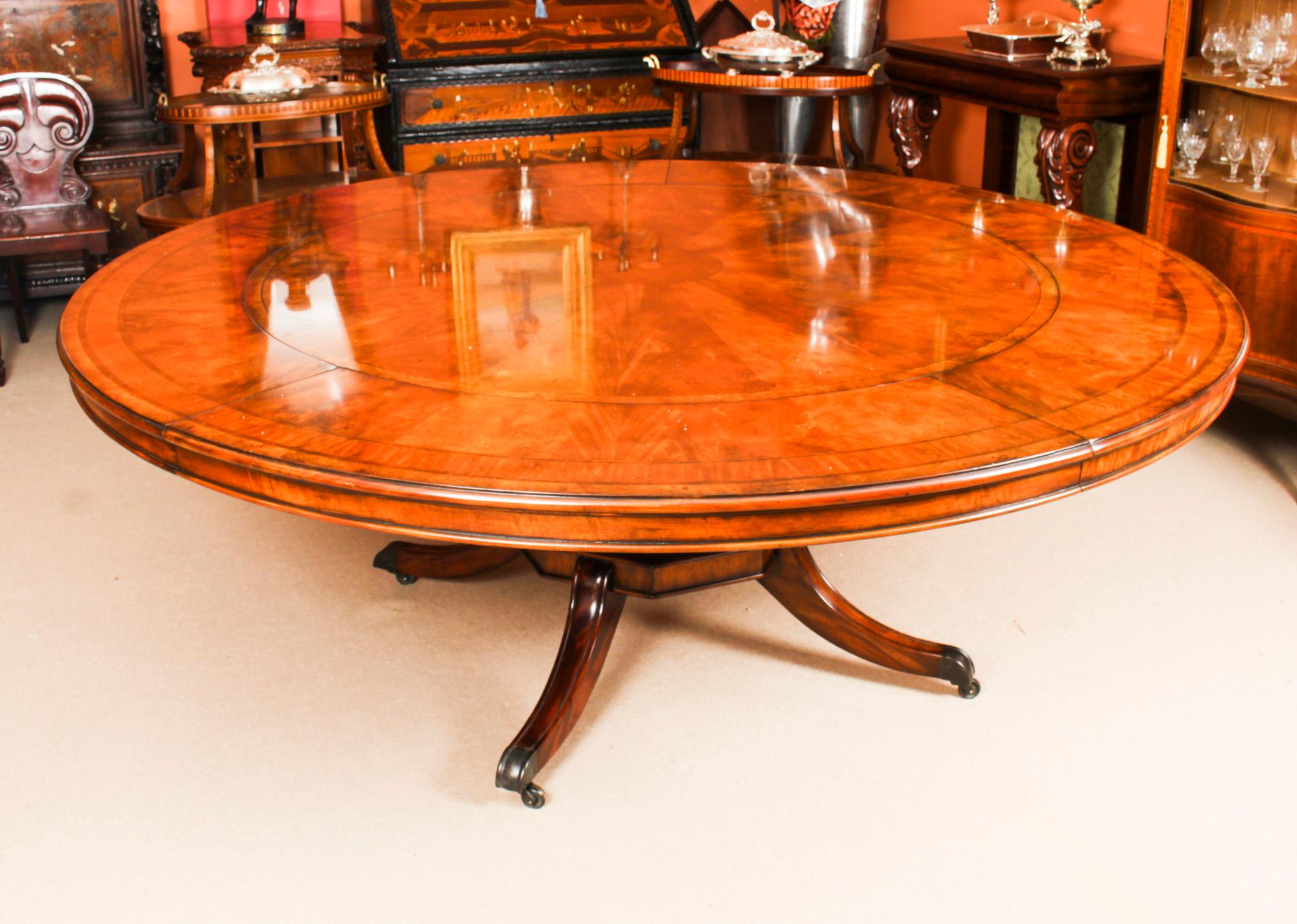 This is a wonderful quality 20th Century example of Robert Jupe's flame mahogany circular extending dining table, dating from the second half of the 20th century.

This fascinating table illustrates all the very best elements of English