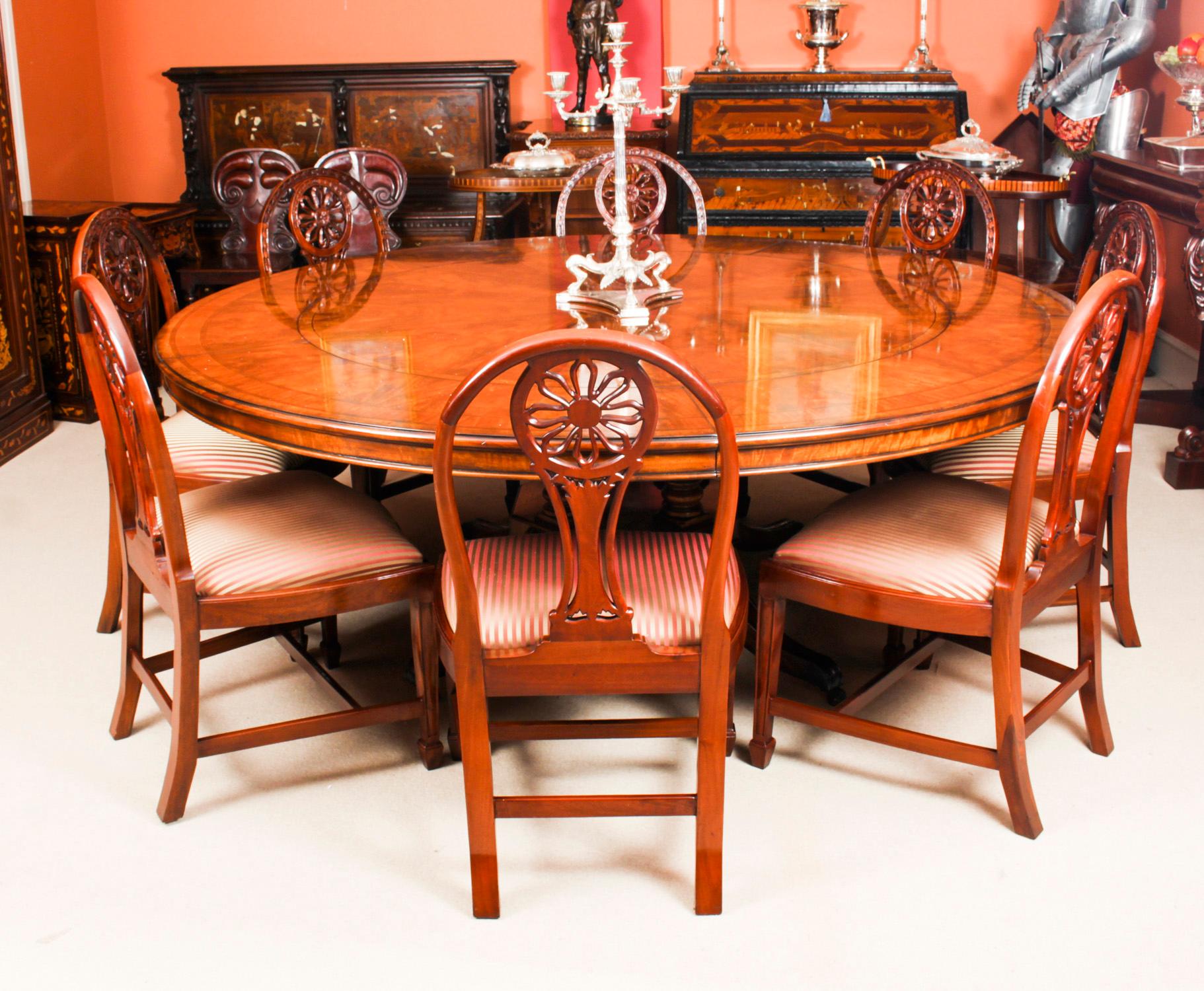 This is a wonderful quality 20th Century example of Robert Jupe's flame mahogany circular extending dining table with a set of eight dining chairs, all dating from the second half of the 20th century.
 
This fascinating table illustrates all the
