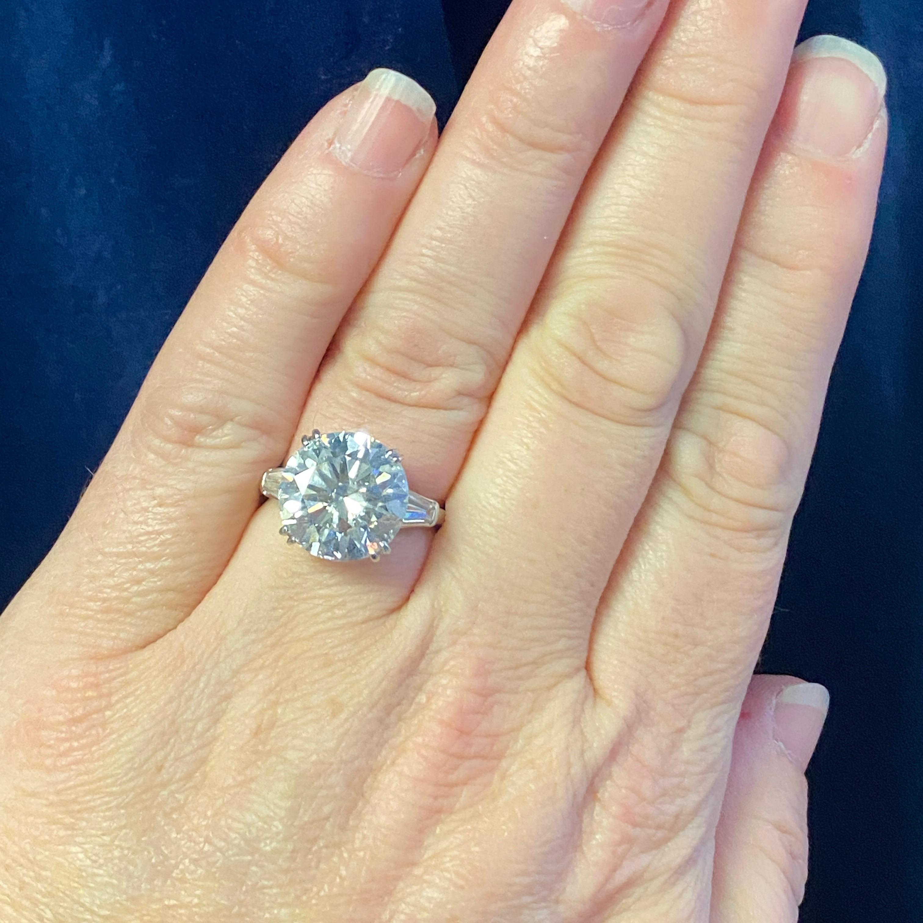 This gorgeously preserved vintage platinum 3-stone diamond ring has a round brilliant diamond in four double prongs. Tapered baguette diamonds flank the center stone for a timeless three-stone ring design.
An appraisal is included with purchase.
The