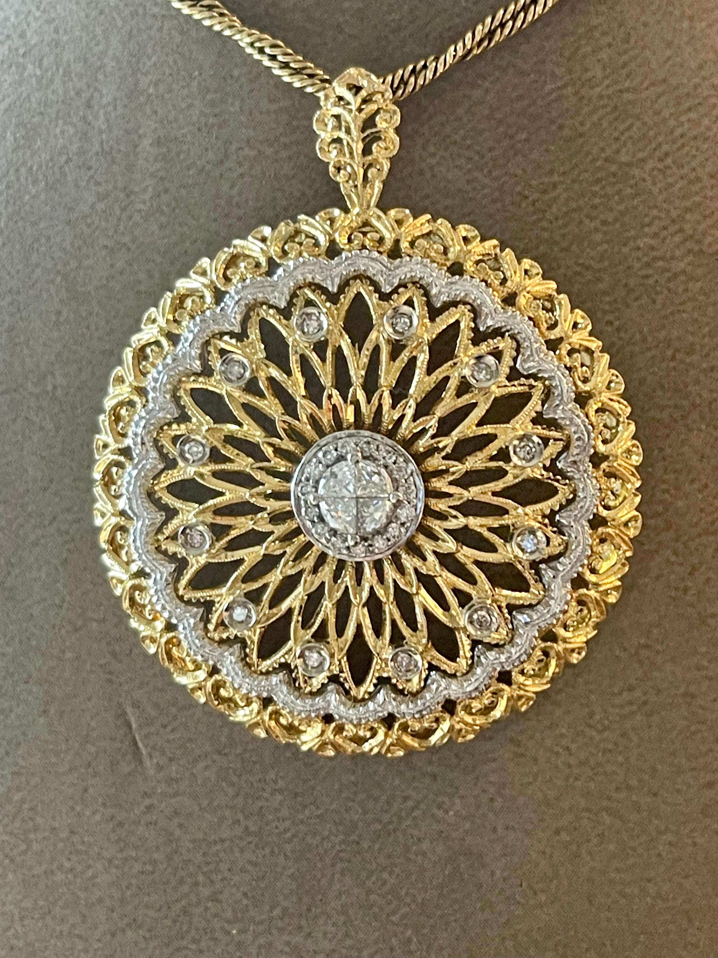 Lovely 18 K yellow and white Gold open work filigree pendant and chain. Set with tiny brilliant cut Diamonds. Finished with milgrain edges.
The length of the chain is 41.5 cm. Total weight 22.56 grams. Dimension of pendant: width 3.90 cm and height