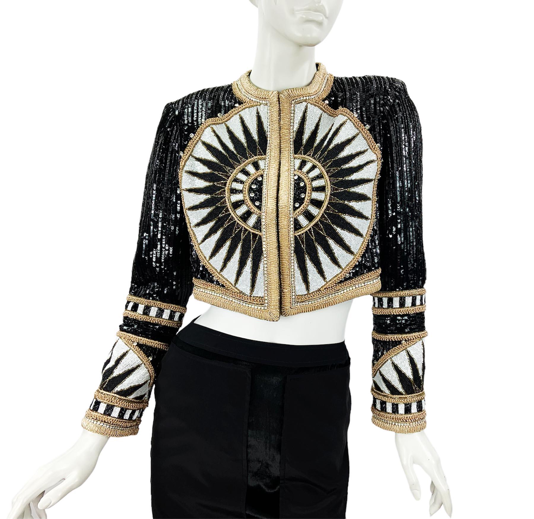 Bob Mackie for Elizabeth Arden Vintage 80's Bolero Jacket
Size - Small
Exquisitely beaded with black, white, clear, gold and amber colored beads and sequins. 
Additionally embroidered with metallic gold few types of trim.
Fully lined. Open