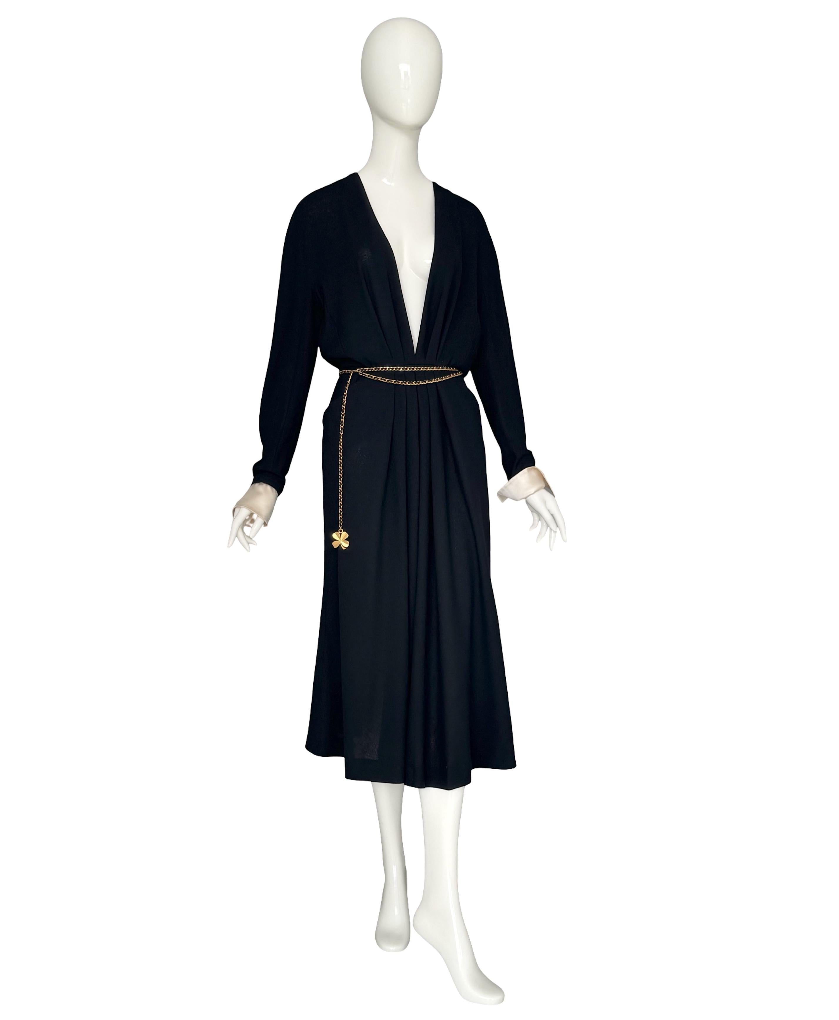 Rare Vintage 1980s Chanel Boutique Black Deep V-Neck Pleated Crepe Dress, Designed by Karl Lagerfeld. 

Step into timeless sophistication with this authentic vintage Chanel Boutique dress from the iconic 1980s era, a stunning creation by Karl