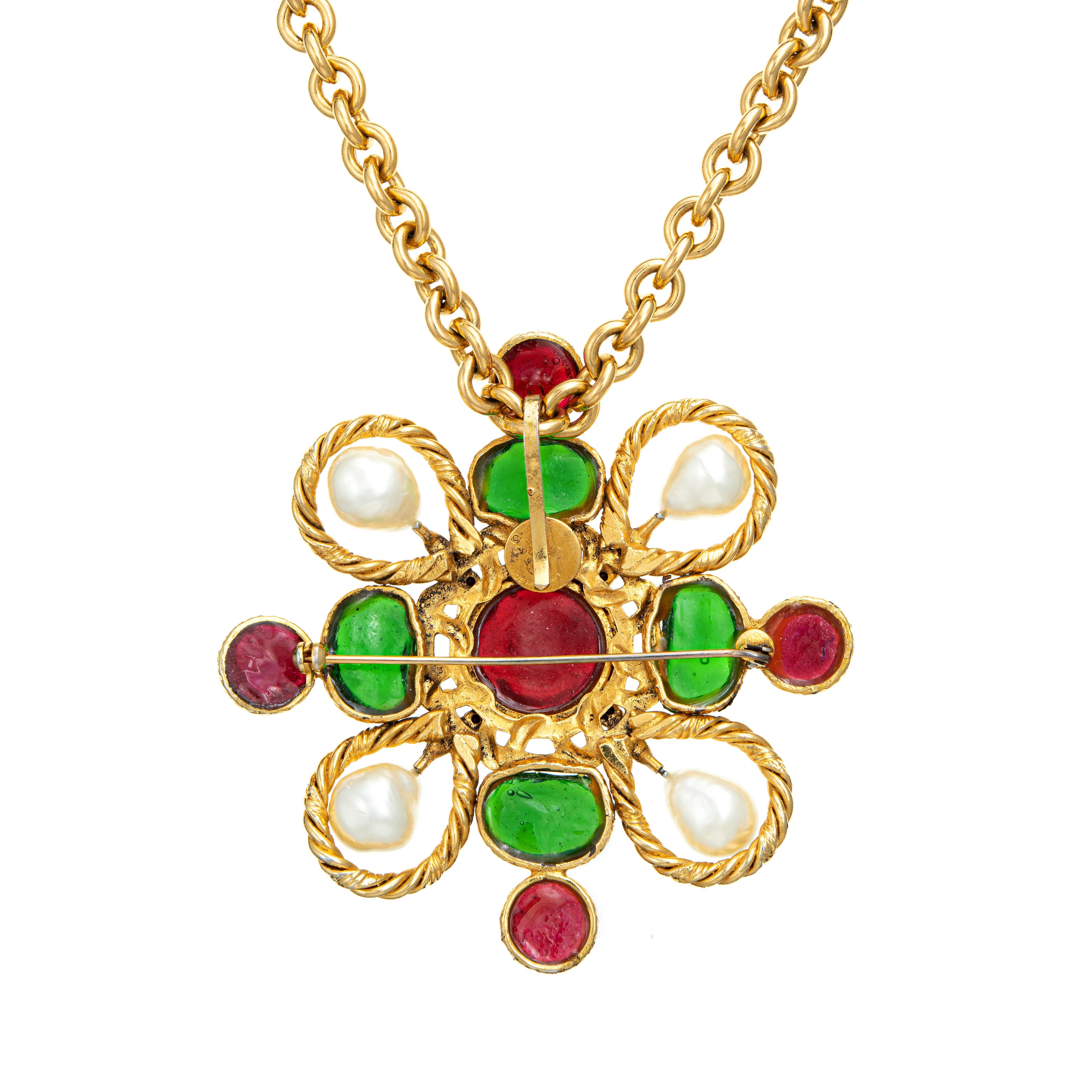 Beautiful vintage Chanel Gripoix necklace (circa 1980s) crafted in a yellow metal tone. 

Colored green and red glass, faux pearls and small crystals are set into the medallion. The long 21