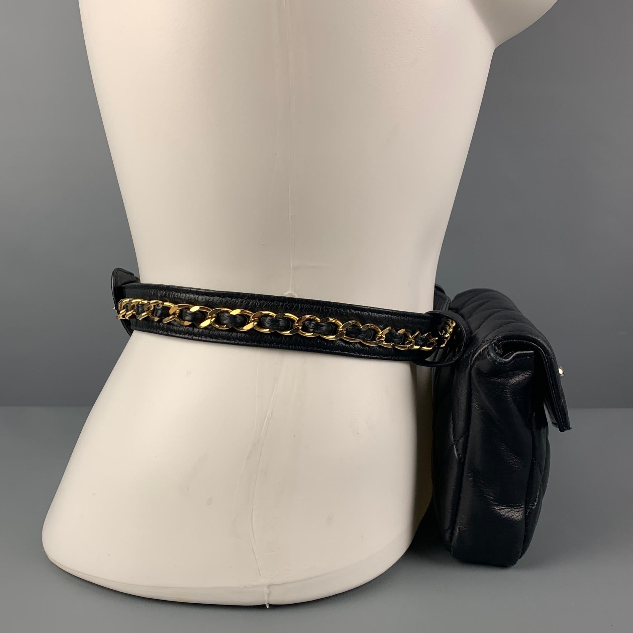 Vintage 80's CHANEL belt-bag comes in a black quilted leather featuring a removable chain belt strap, gold tone hardware, inner pocket, and signature CC closure. Comes with box. Made in Italy. 

Very Good Pre-Owned Condition.

Measurements:

Length: