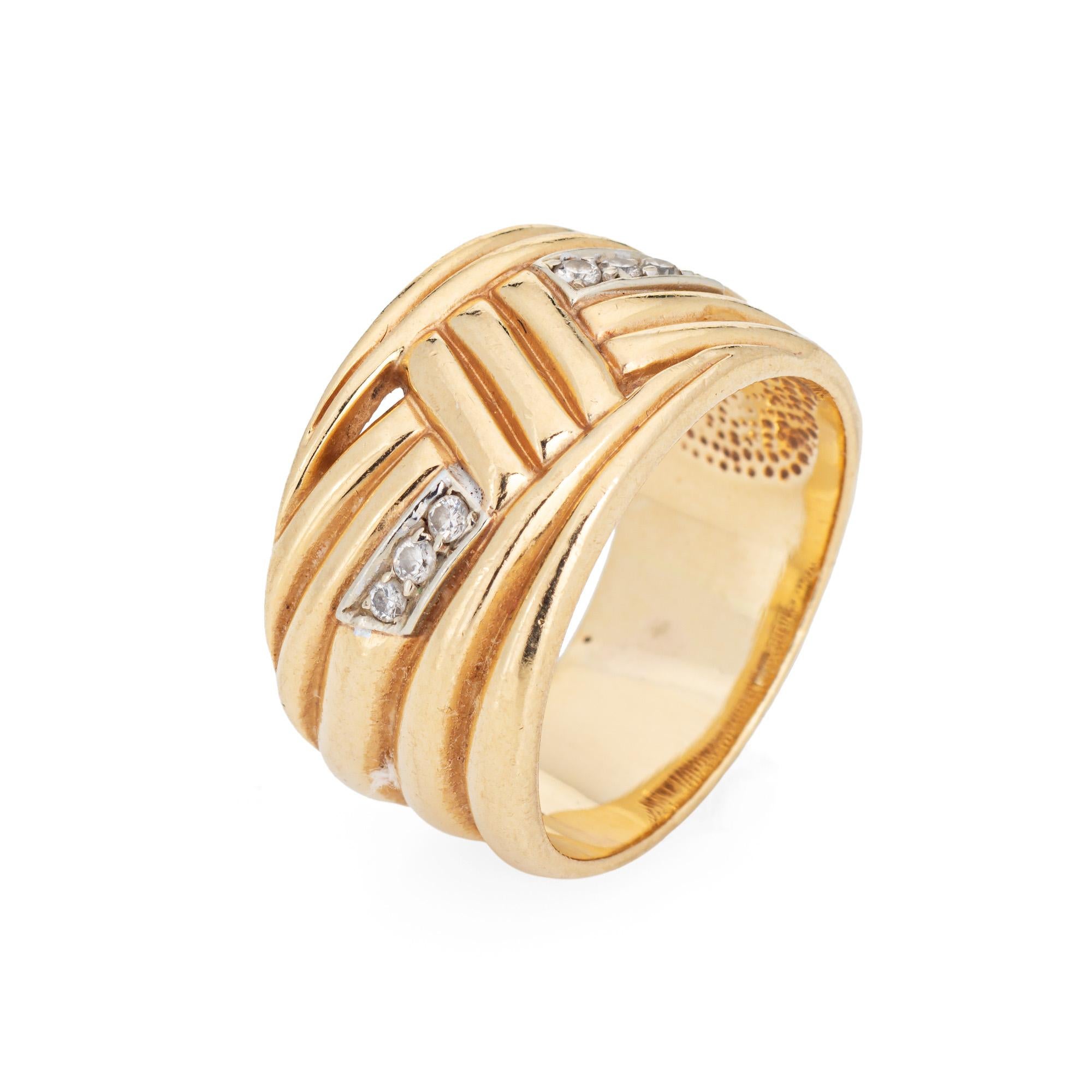 Stylish vintage diamond wide band crafted in 14 karat yellow gold (circa 1980s). 

Six diamonds total an estimated 0.06 carats (estimated at H-I color and SI1-I1 clarity). 

With an opposing ridged design the wide band (12.5mm - 0.49 inches) sits