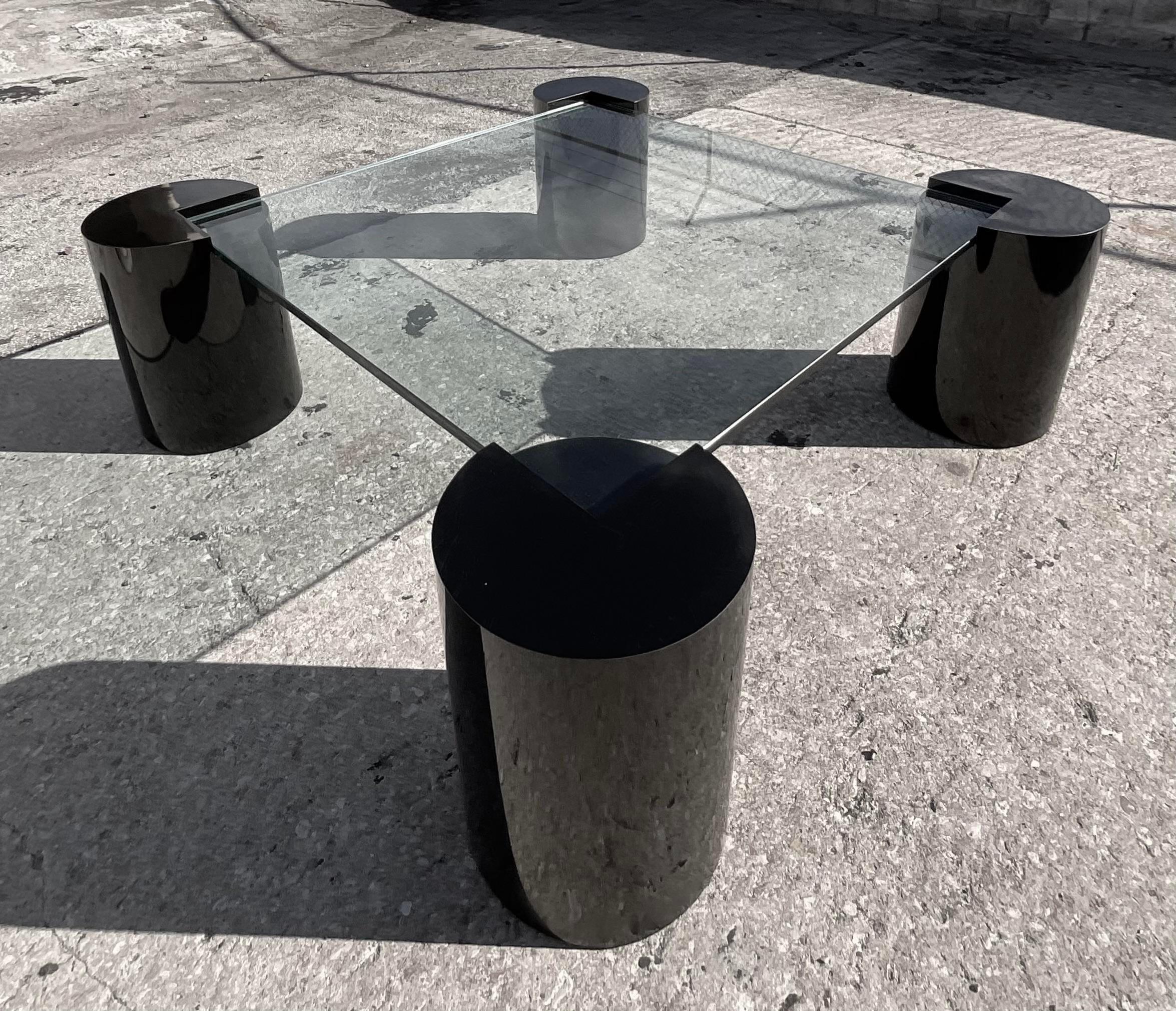 Fantastic monumental vintage 80;s coffee table. Four chic cylinder pedestals in a gloss black with an inset glass top. Super glamorous. Done in the manner of Karl Springer. Acquired from a Miami estate. 