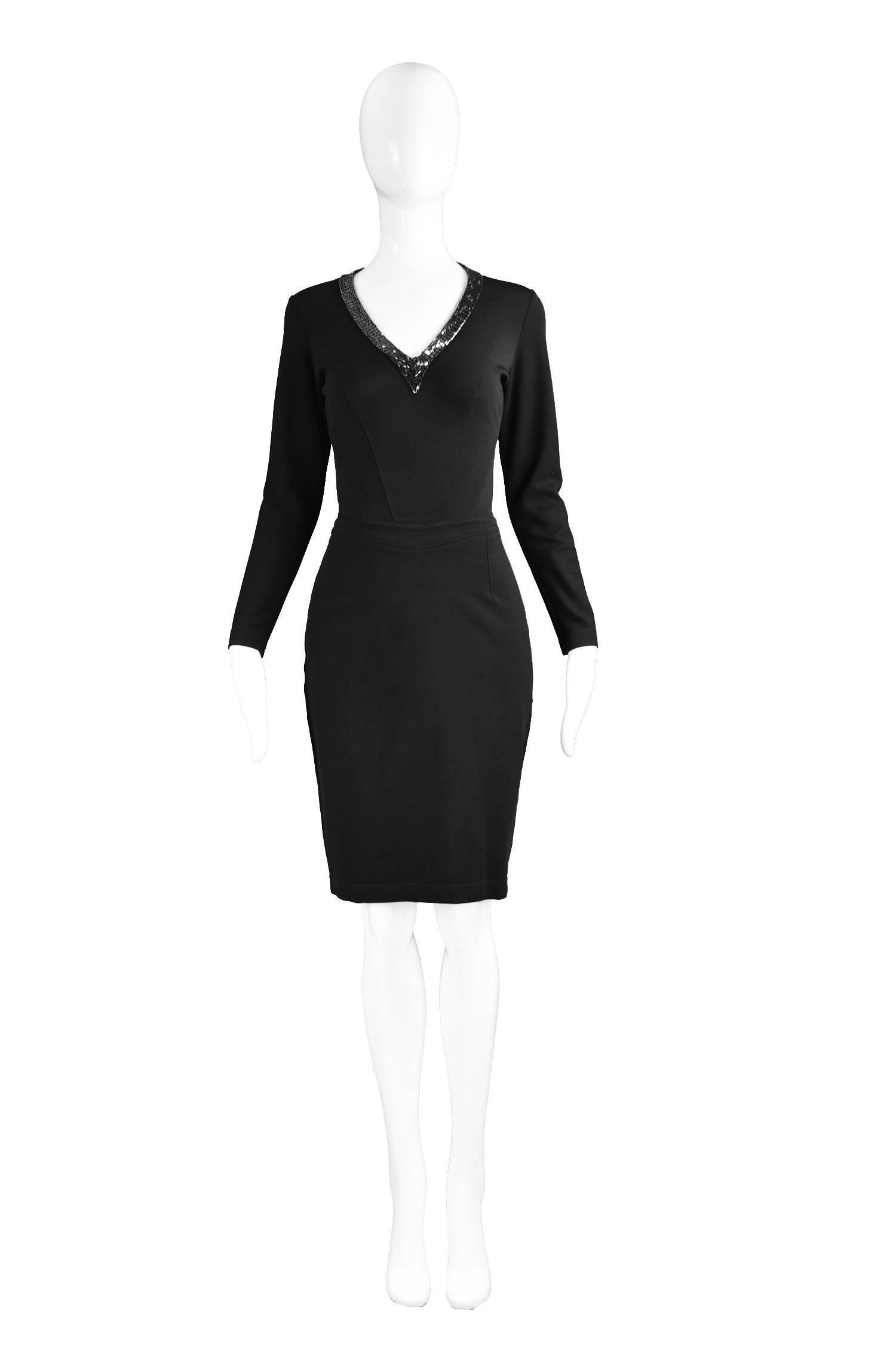 A chic vintage little black LBD dress from the 90s by iconic British fashion designer, Jasper Coran for his high end mainline, which was sold at luxury department store, Harrods. In a black ponta roma rayon and elastane double knit jersey with an