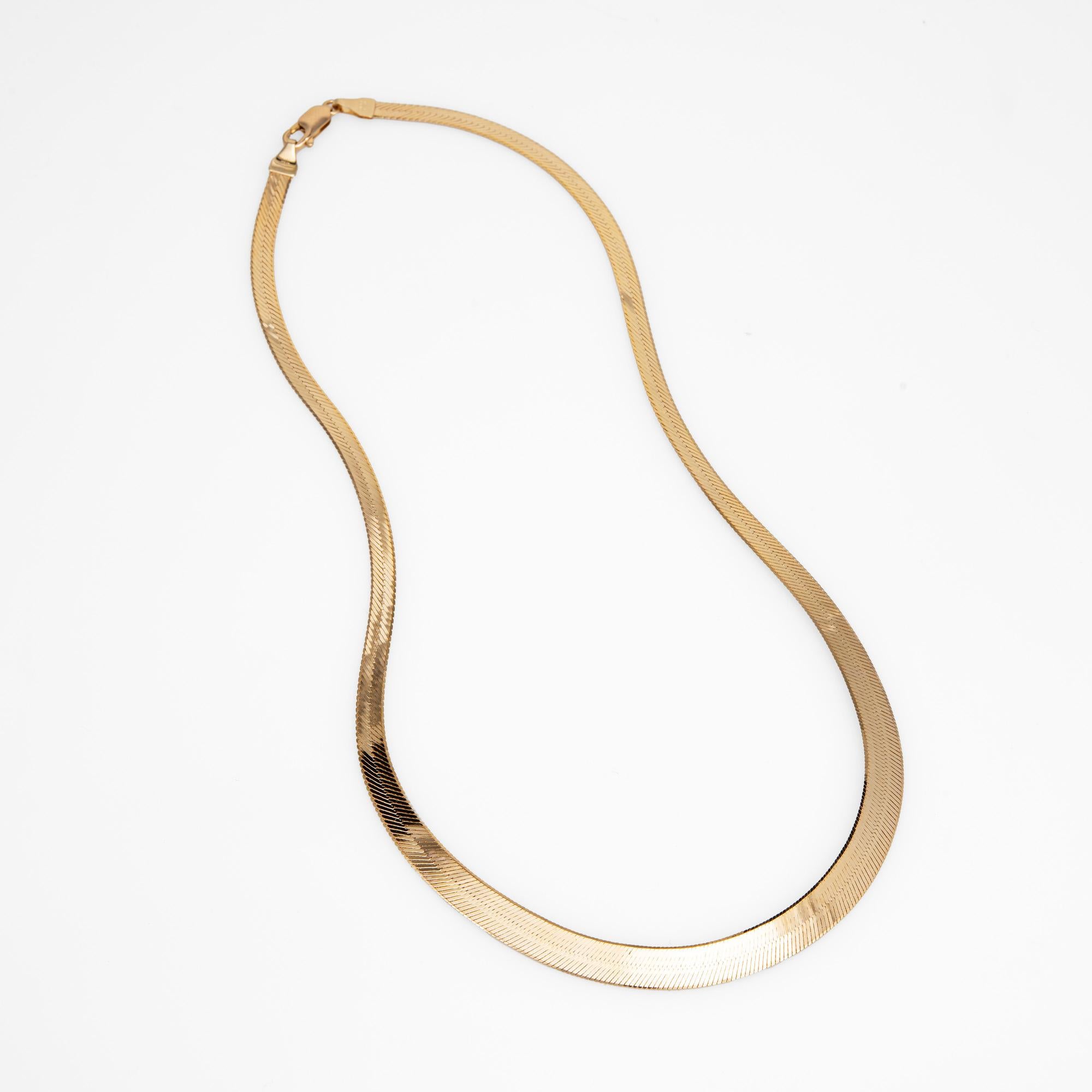 Elegant and finely detailed 14 karat yellow gold herringbone necklace (circa 1980s).  

The necklace measures 17 inches in length and sits nicely just below the nape of the neck. The necklace graduates in width from 4mm to 7mm. The necklace is great