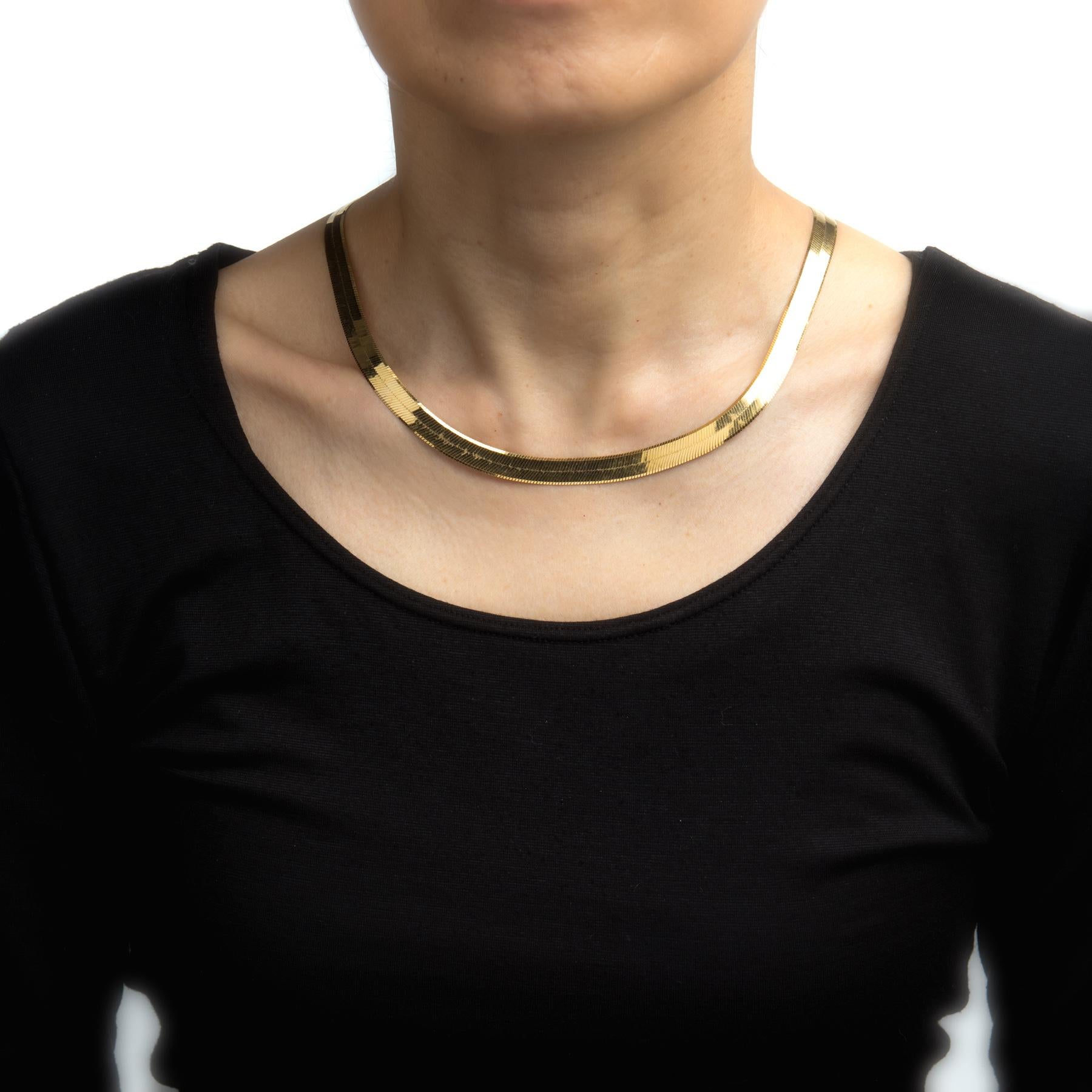 Elegant and finely detailed 14 karat yellow gold herringbone necklace.  

The necklace measures 18 inches in length and sits nicely just below the nape of the neck. The necklace measures 8mm wide. The necklace is great worn alone or layered with