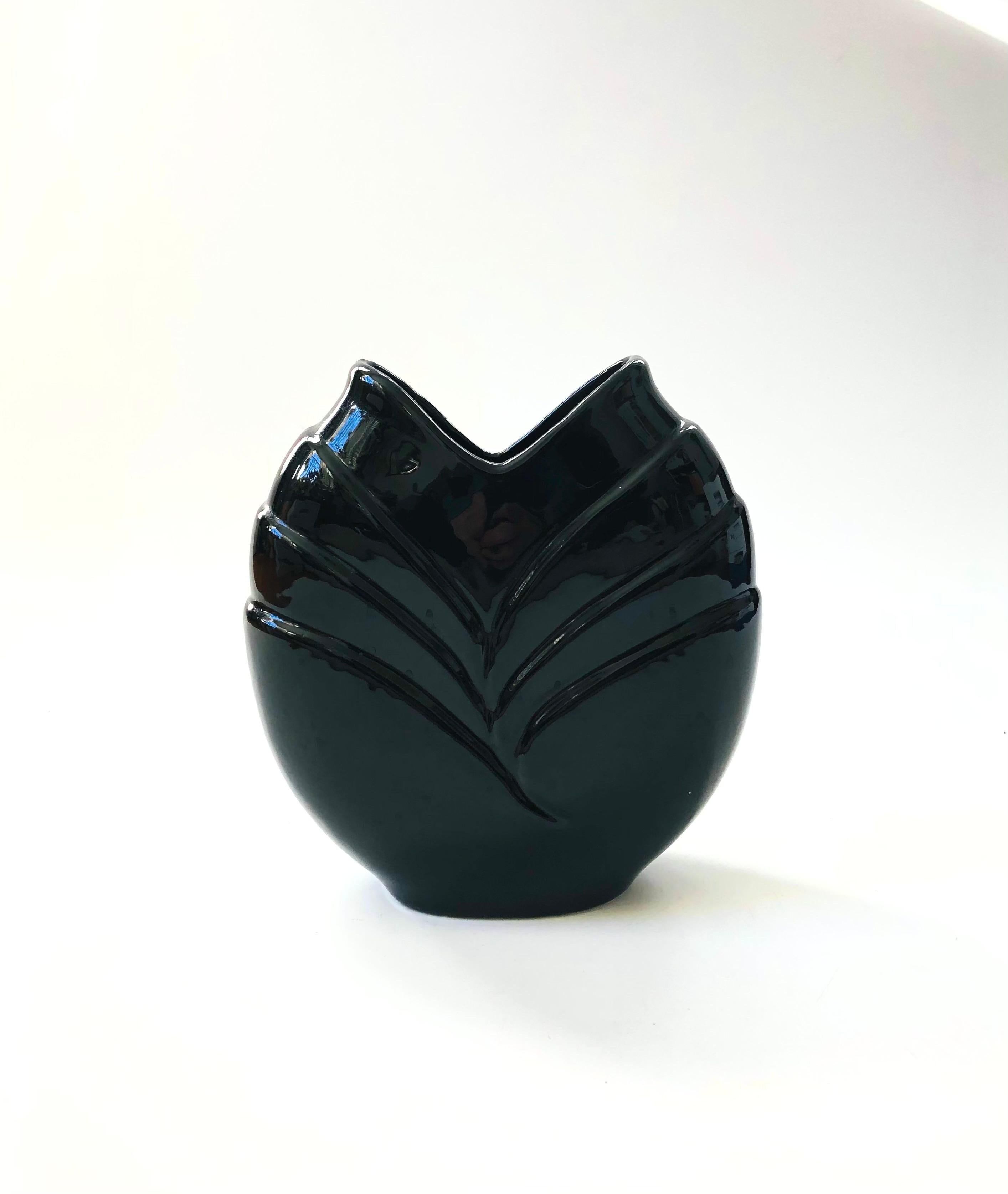 A wonderful vintage 80s modern ceramic vase. High gloss black finish with a curved embossed design formed onto each side.

