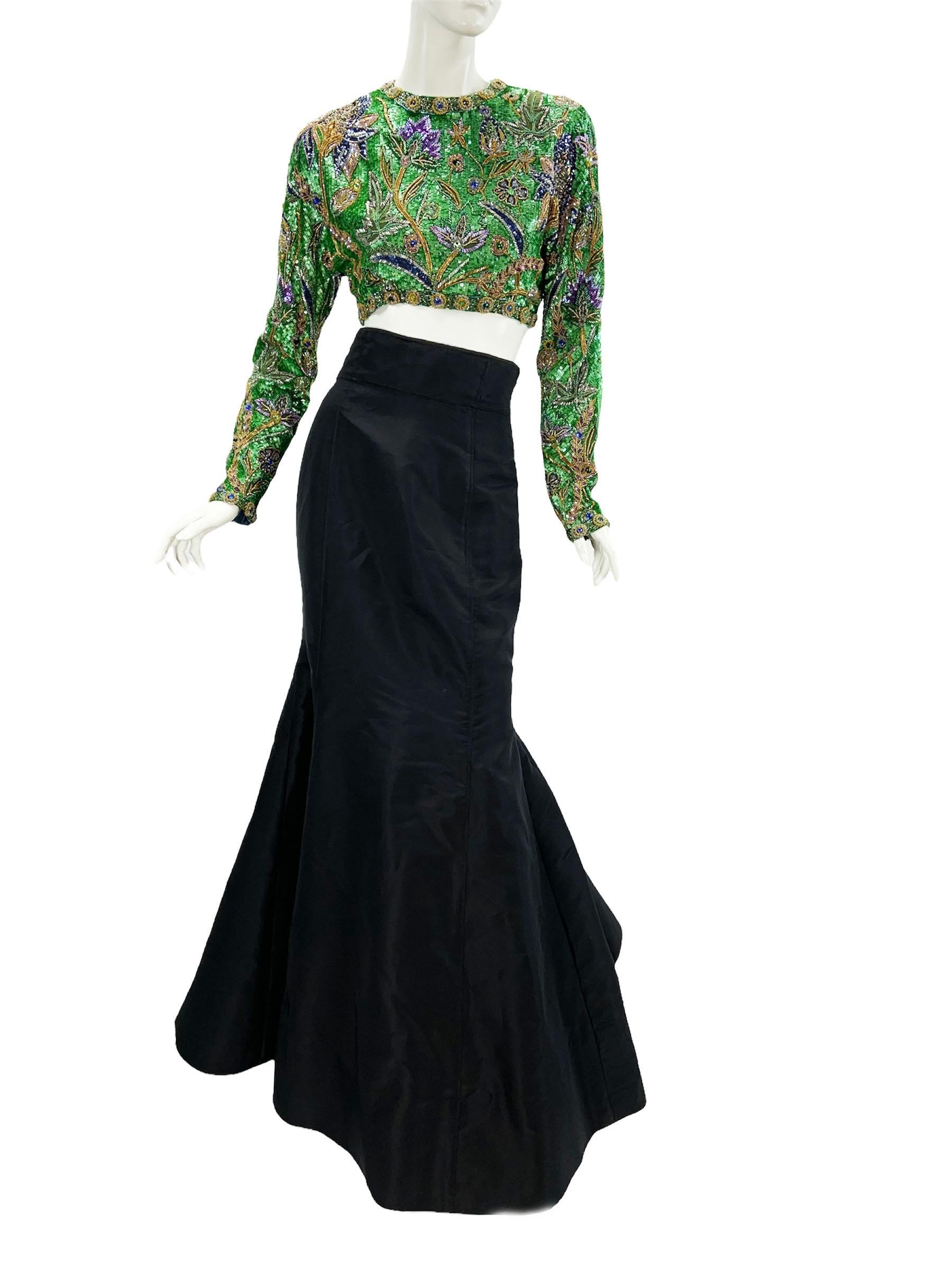 Vintage 80's Oscar De La Renta Embellished Skirt Set
Reversible Fully Exquisitely Hand Beaded and Sequined Bolero in Emerald Green Background with Purple Iris Flowers. 
Jeweled Medallions Adorn the Edging and Cuffs. Dolman Sleeves. Fully Lined. Open