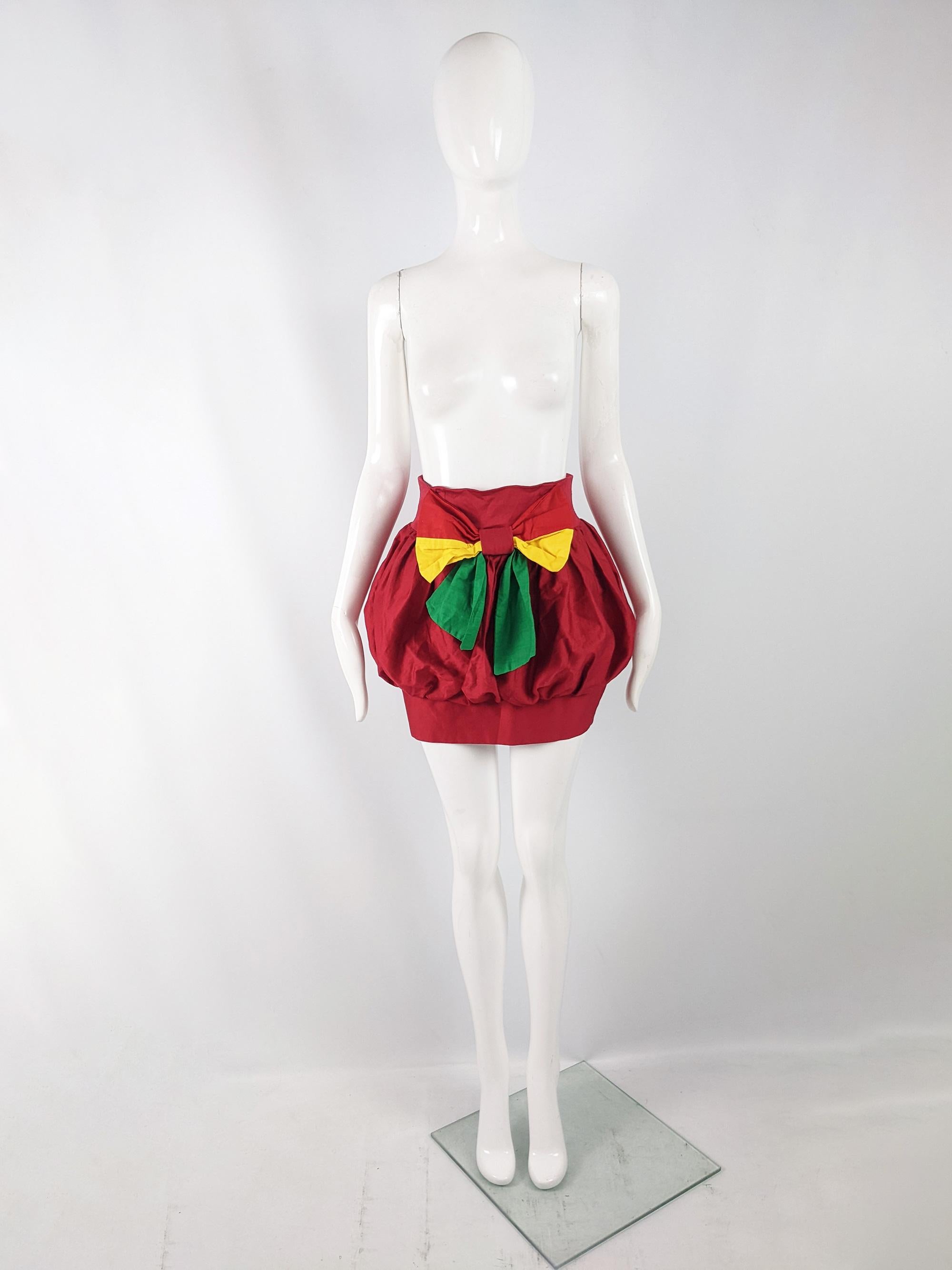 A sexy vintage womens mini bubble skirt from the 80s in a red cotton with a dramatic bow to the front and a puffball silhouette that has a tight pencil/ wiggle like hem. Perfect for a party or evening event.

Size: Marked vintage 10 but measures