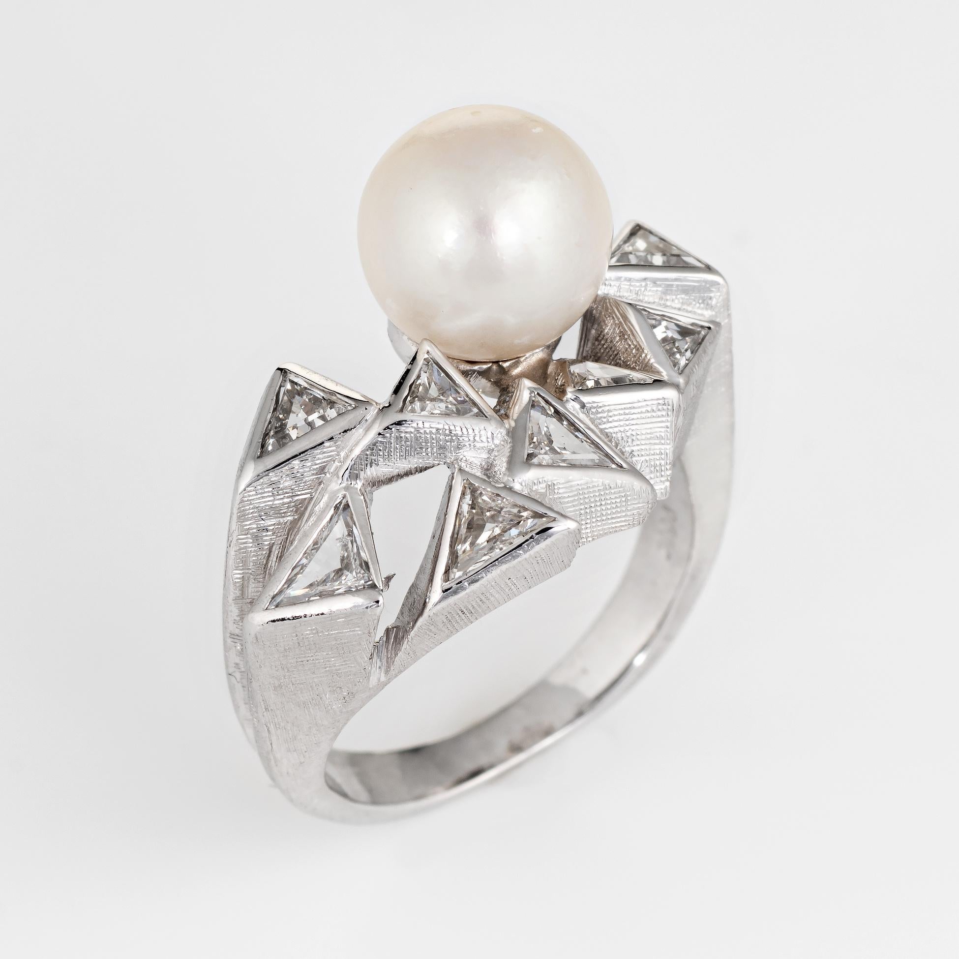 Stylish vintage cultured pearl & diamond ring (circa 1980s), crafted in 14 karat white gold. 

Cultured pearl measures 8mm accented with 8 estimated 0.10 carat trillion cut diamonds. The total diamond weight is estimated at 0.80 carats (estimated at