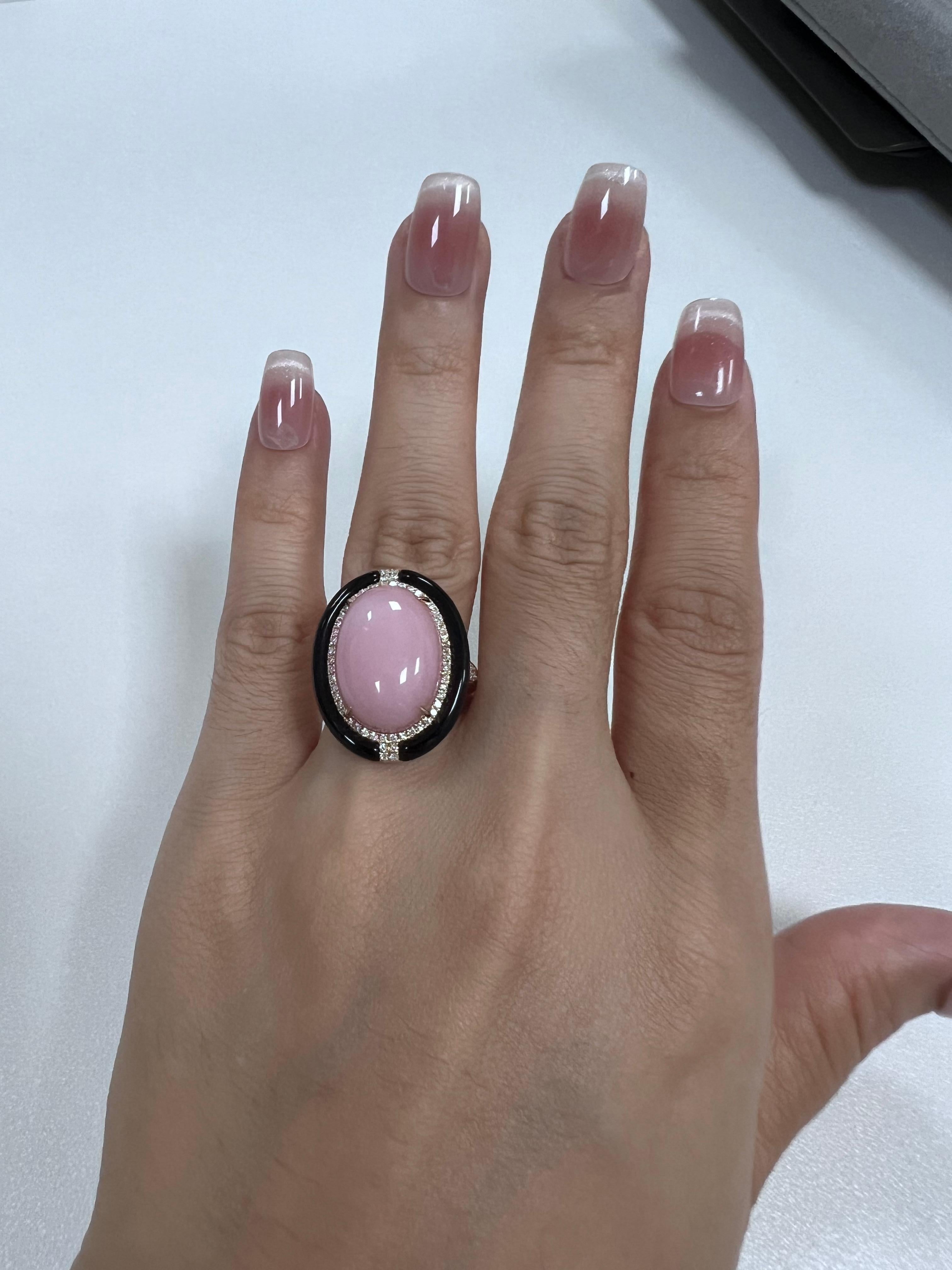 This exquisite ring is crafted in 14-karat yellow gold, featuring a stunning combination of gemstones. The centerpiece is an 8.43-carat pink opal, encircled by a striking 2.5-carat onyx frame that highlights its natural pink opal. Adorning the band